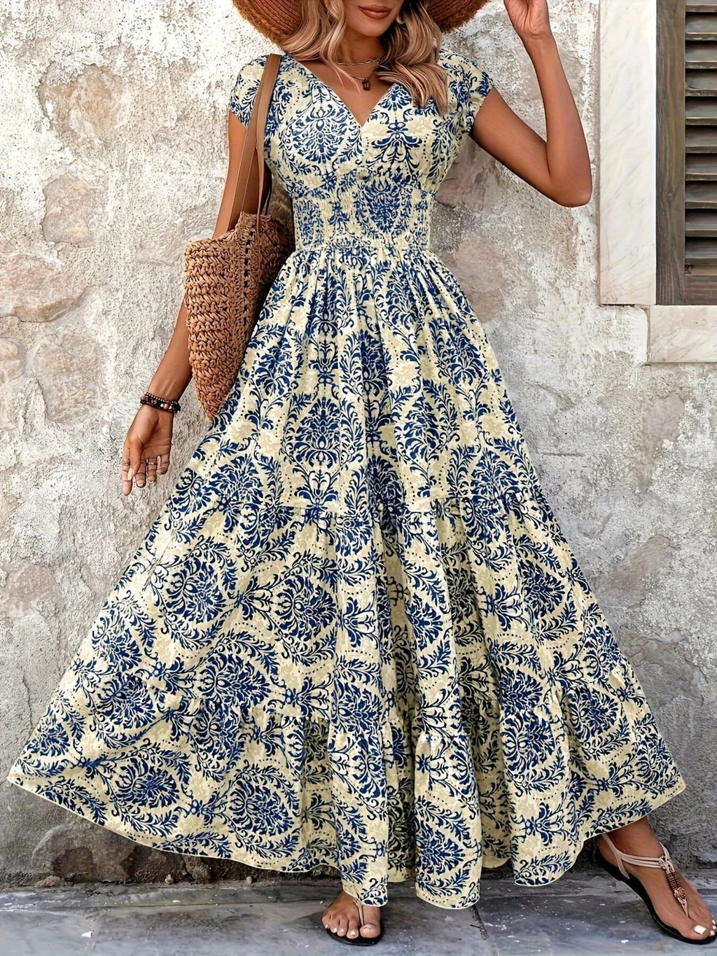 Printed cap-sleeve maxi dress in blue on cream with tiered, smocked bodice.