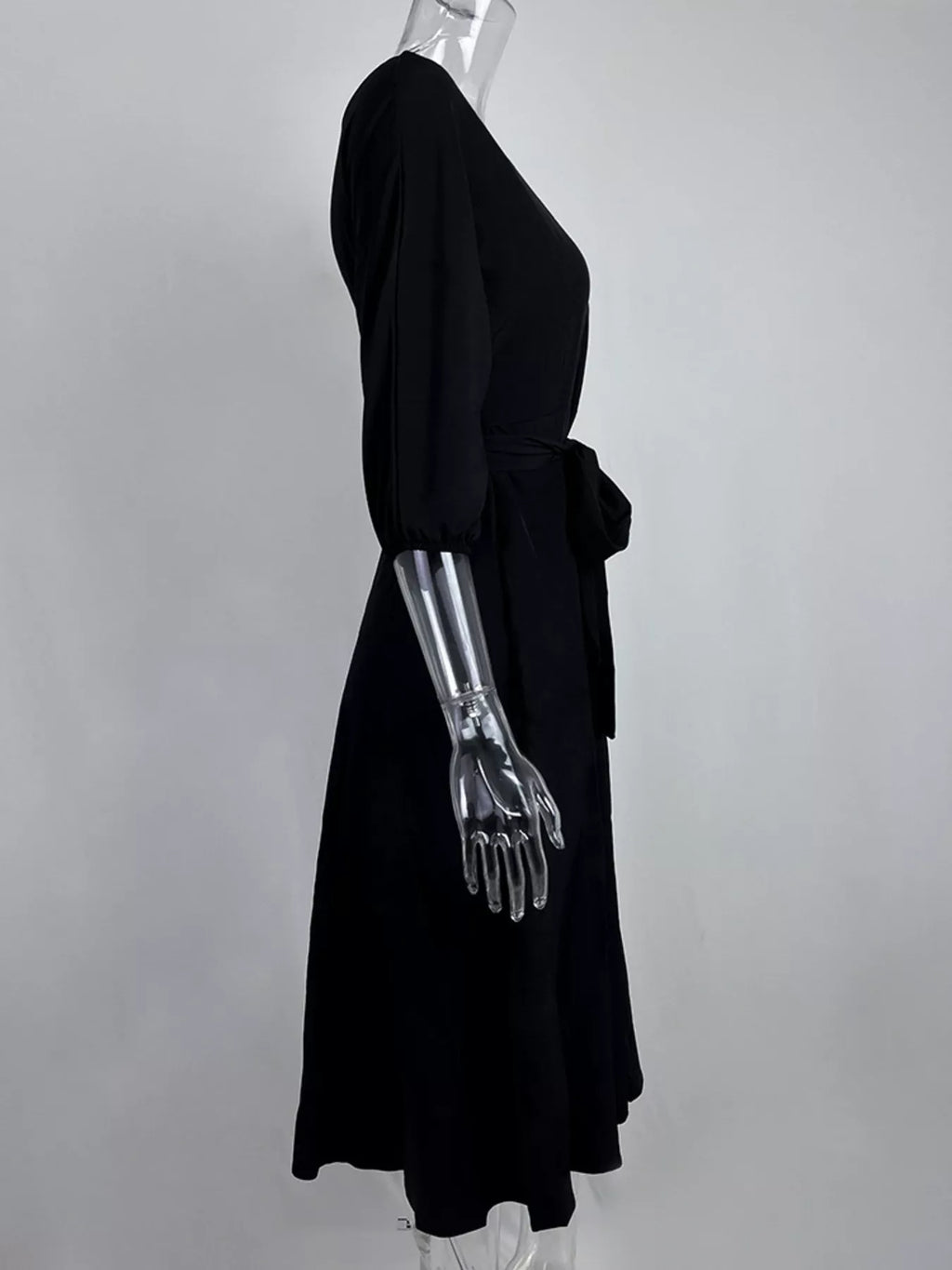 Boat Neck Tie Waist Dress by Trendsi in black with long sleeves and elastic cuffs and a self-tie waist.
