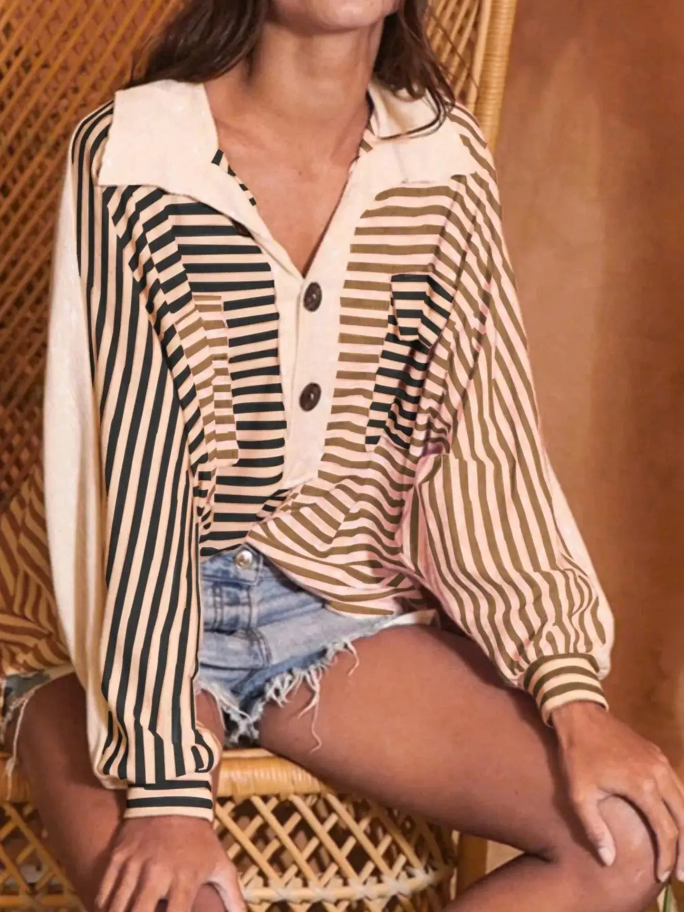 Striped oversized half-button sweatshirt top with a collar and long sleeves in ivory with tan and black stripes.