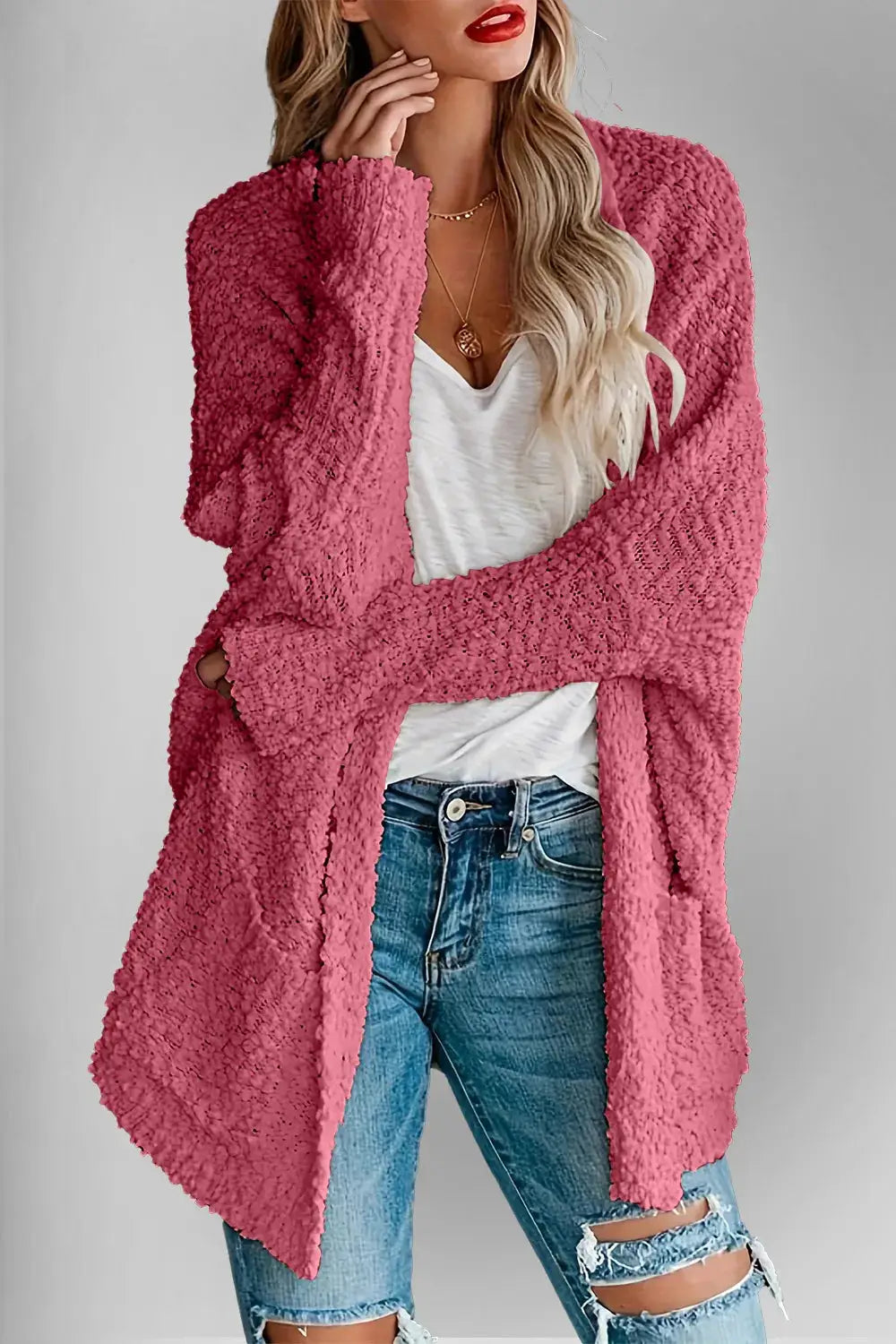 Double Take pink pocketed open-front long-sleeve cardigan by Belle Bijouix, worn over a white top and distressed jeans.