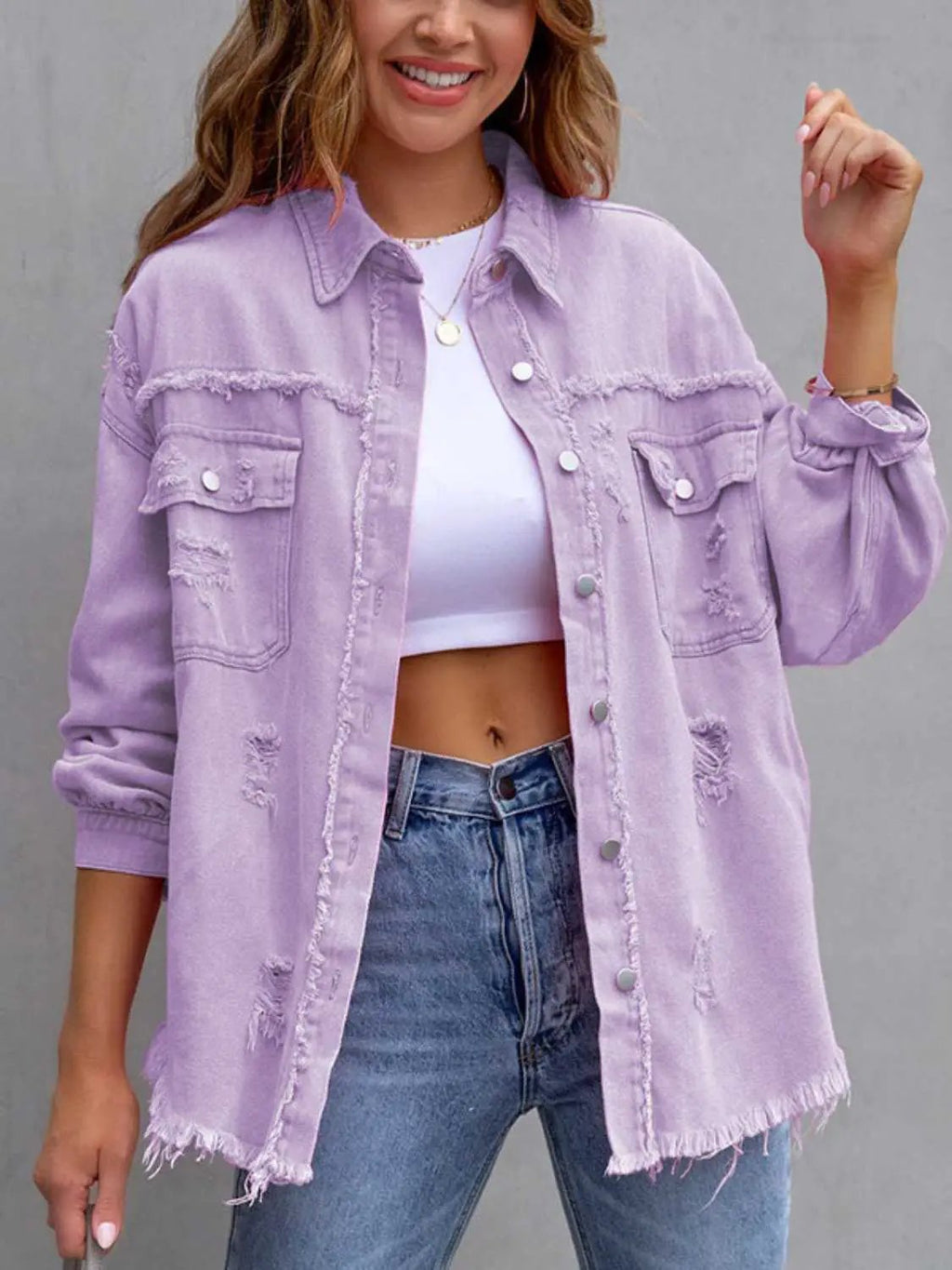 Distressed drop-shoulder denim jacket in lavender with frayed edges and front pockets