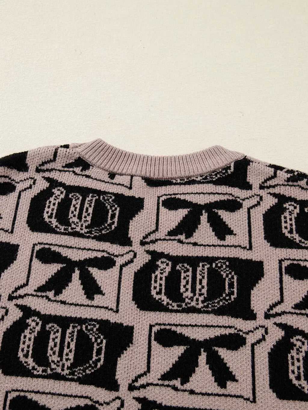 Bows & Horseshoes Pattern Round-Neck Sweater in pale pink with black motif