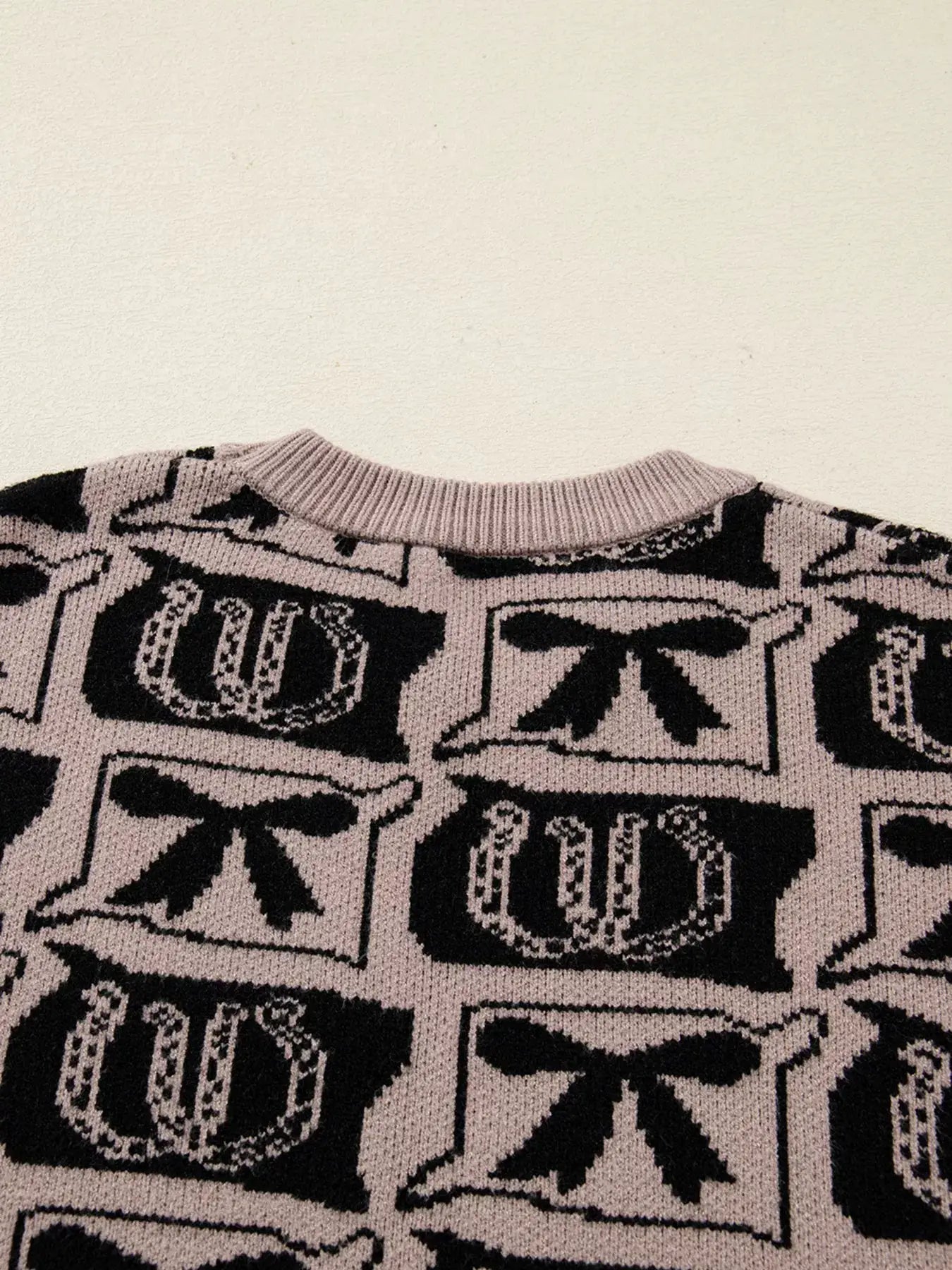 Bows & Horseshoes Pattern Round-Neck Sweater in pale pink with black motif