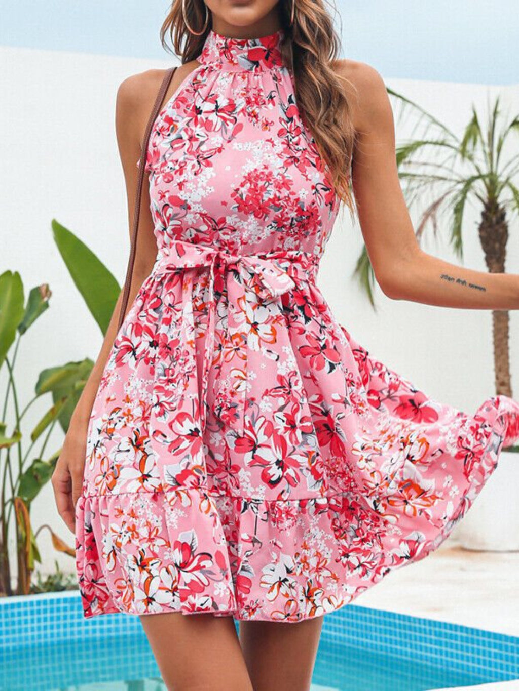 Floral print halter-neck mini dress in pink with a tied waist and ruffles