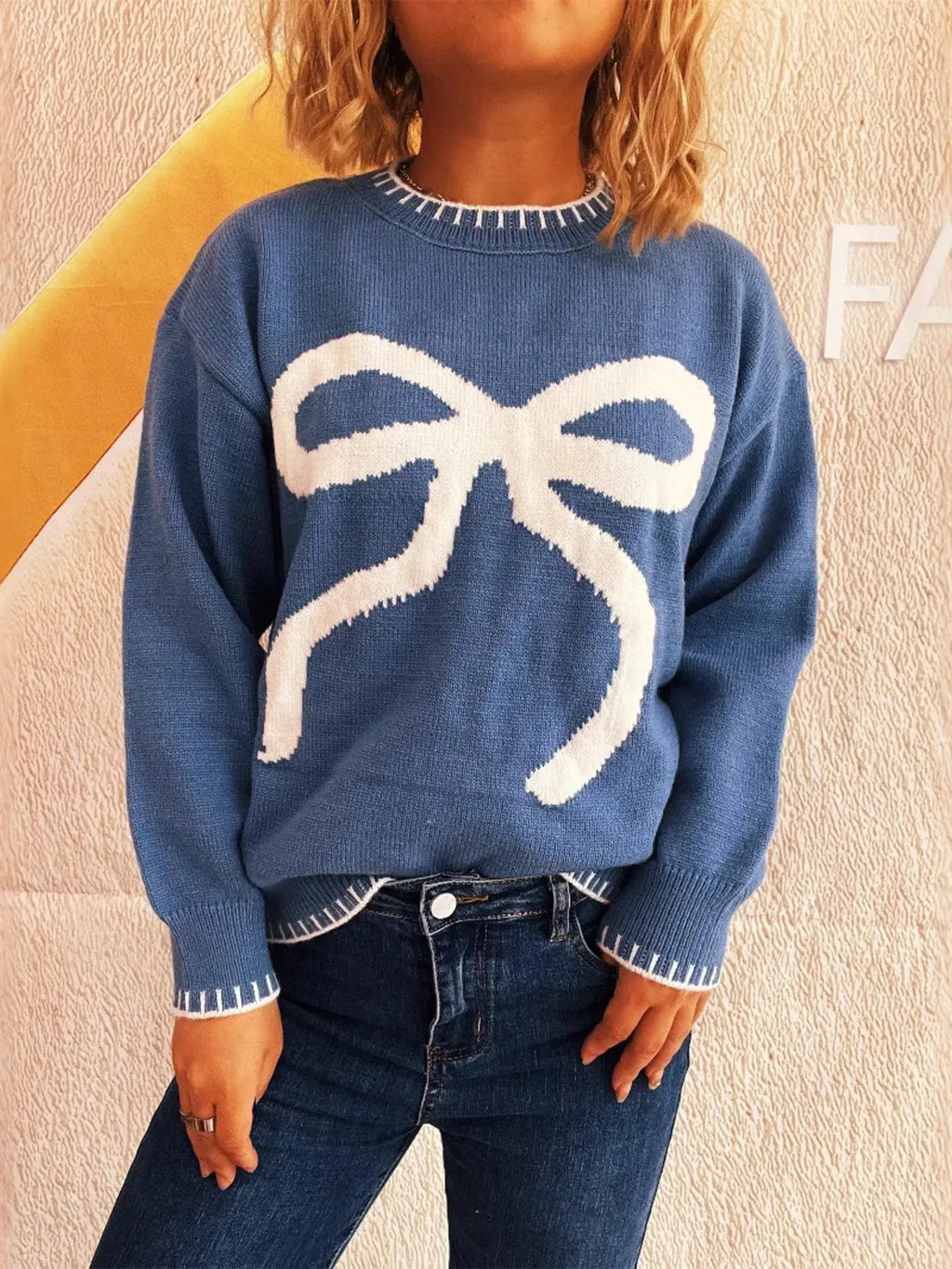 Bow Pattern Round Neck Sweater by Belle Bijouix in blue with white bow graphic.