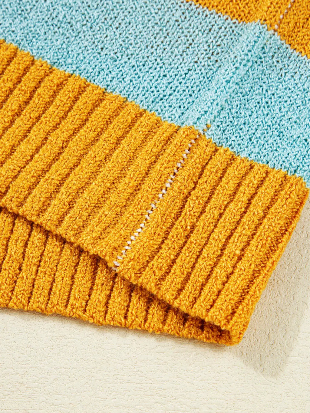 Color Block Striped Sweater in mustard yellow and teal with ribbed knit cuffs.