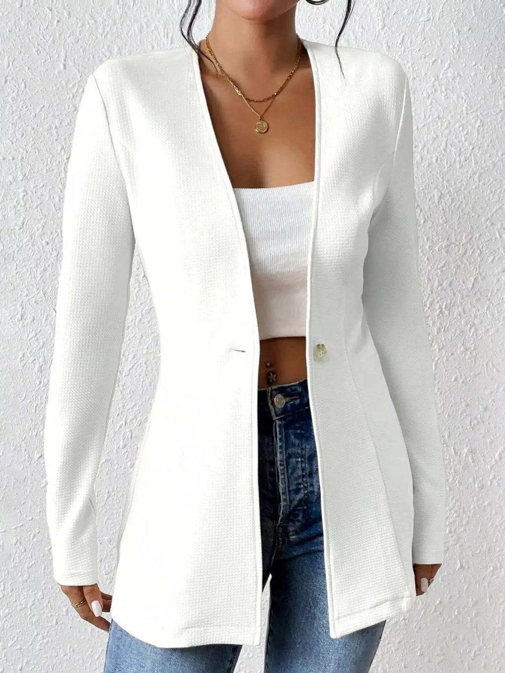 Single-Button Long Sleeve Blazer in white textured fabric; styled with a white cropped top and jeans.