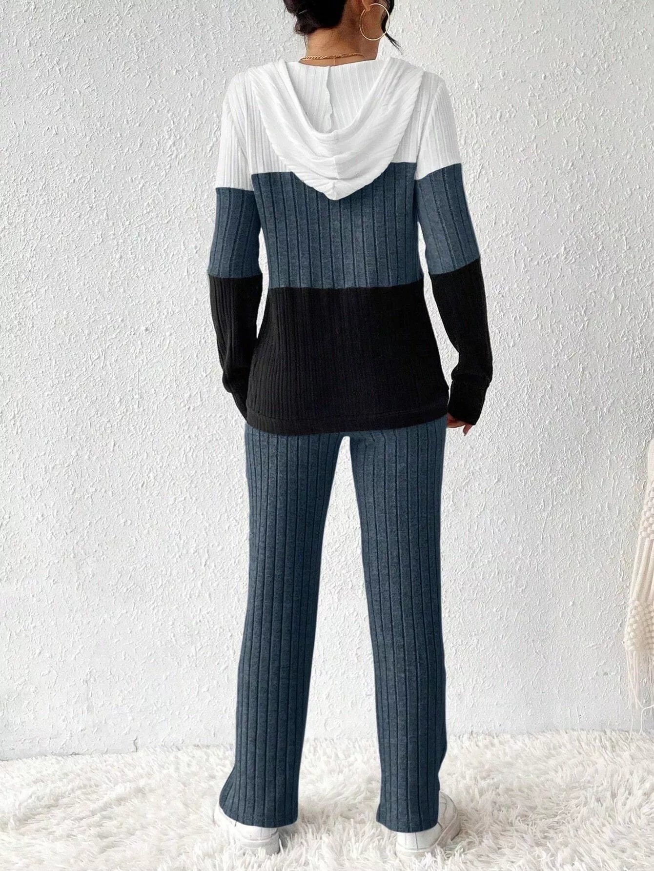 Color-block ribbed knit hooded top and pants set; white upper, blue midsection, black lower; back view.