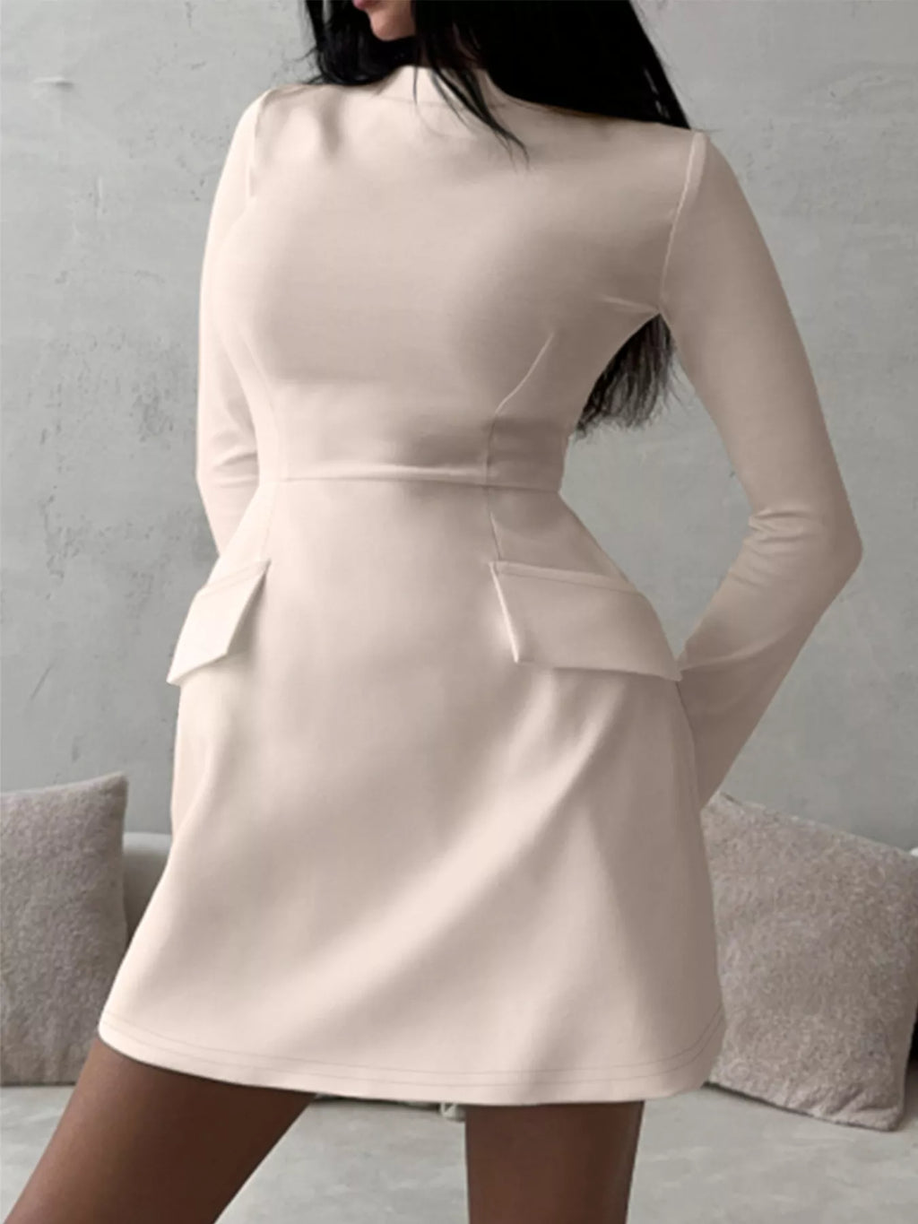 Mock neck long-sleeve bodycon dress in beige, back view with hip flap details