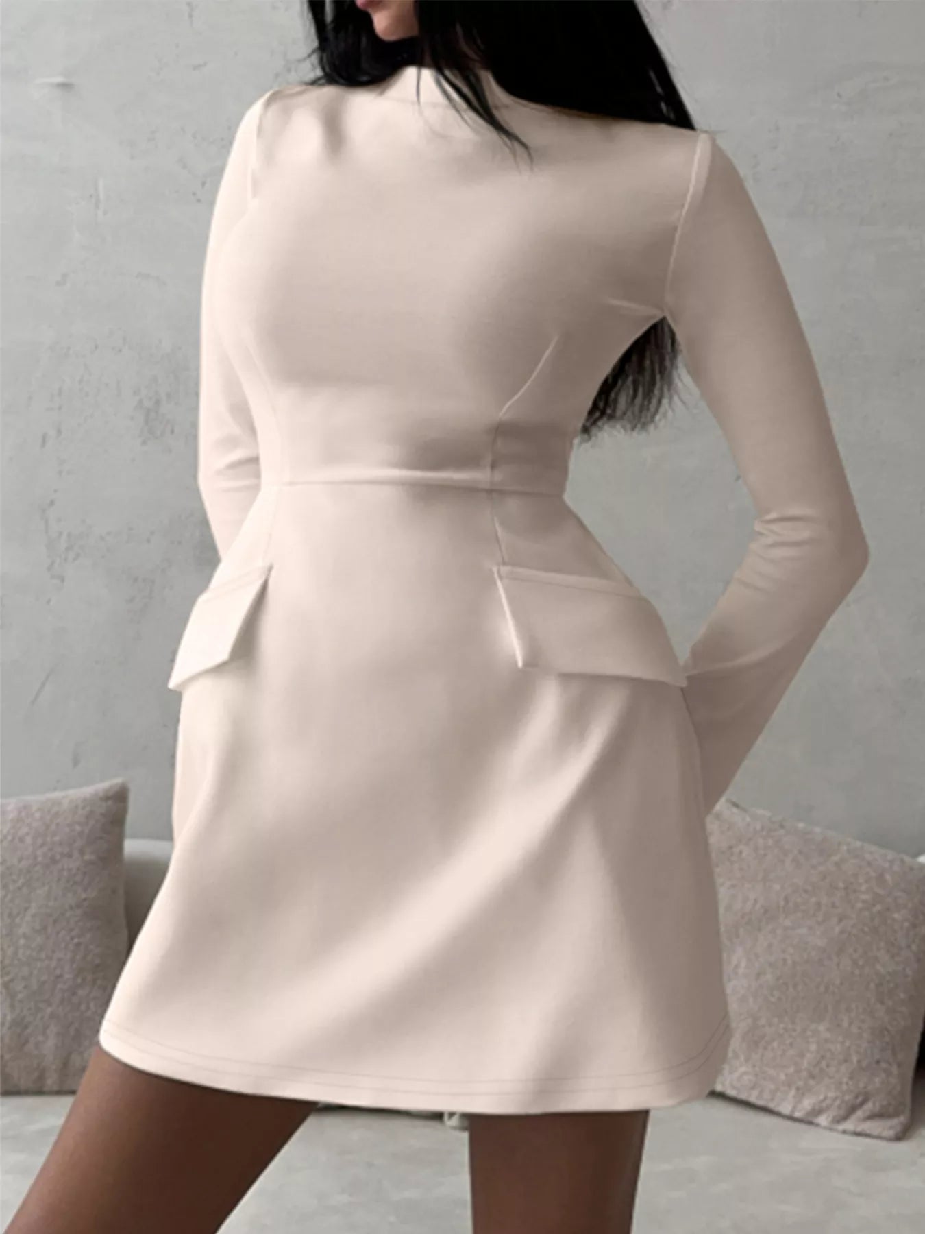 Mock neck long-sleeve bodycon dress in beige, back view with hip flap details