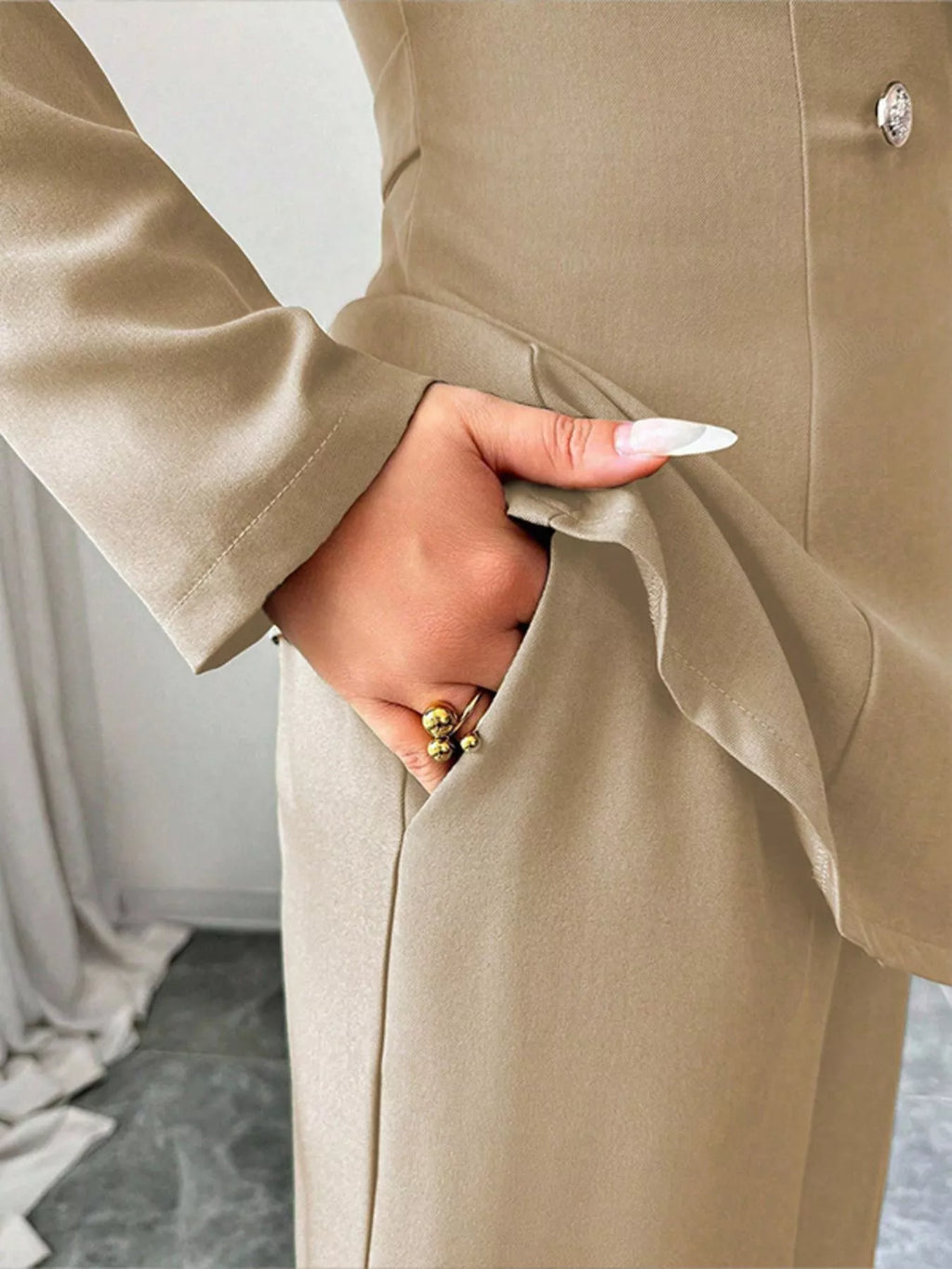 Beige one-button blazer and pants set; pocketed, tailored fabric