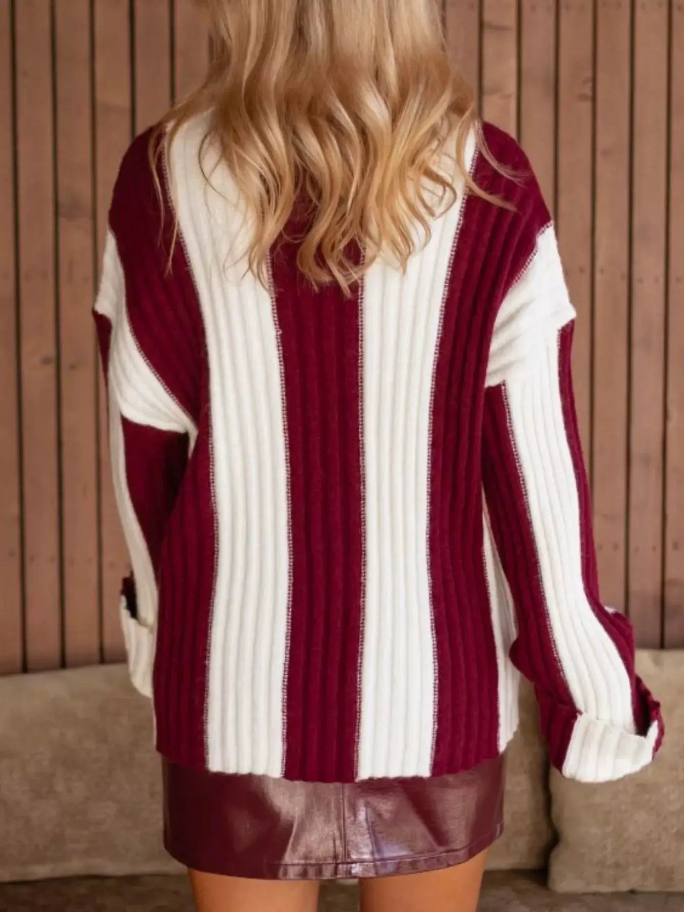 Color-block ribbed sweater in burgundy and cream, back view with vertical stripes.