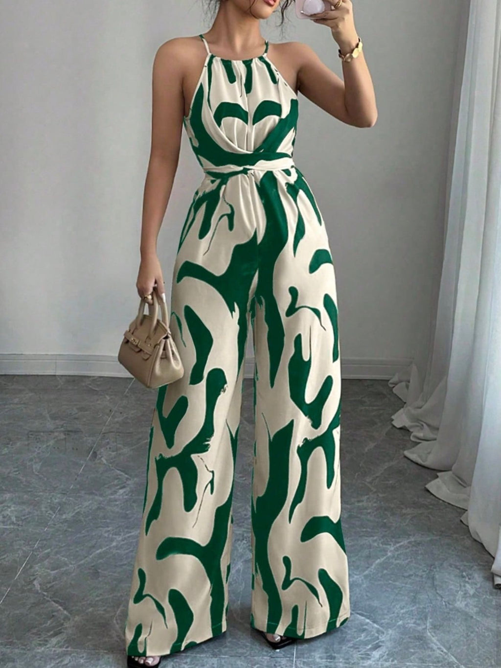 Abstract Print Sleeveless Wide-Leg Jumpsuit by Bellebijouix in beige with green pattern; waist belt and beige handbag