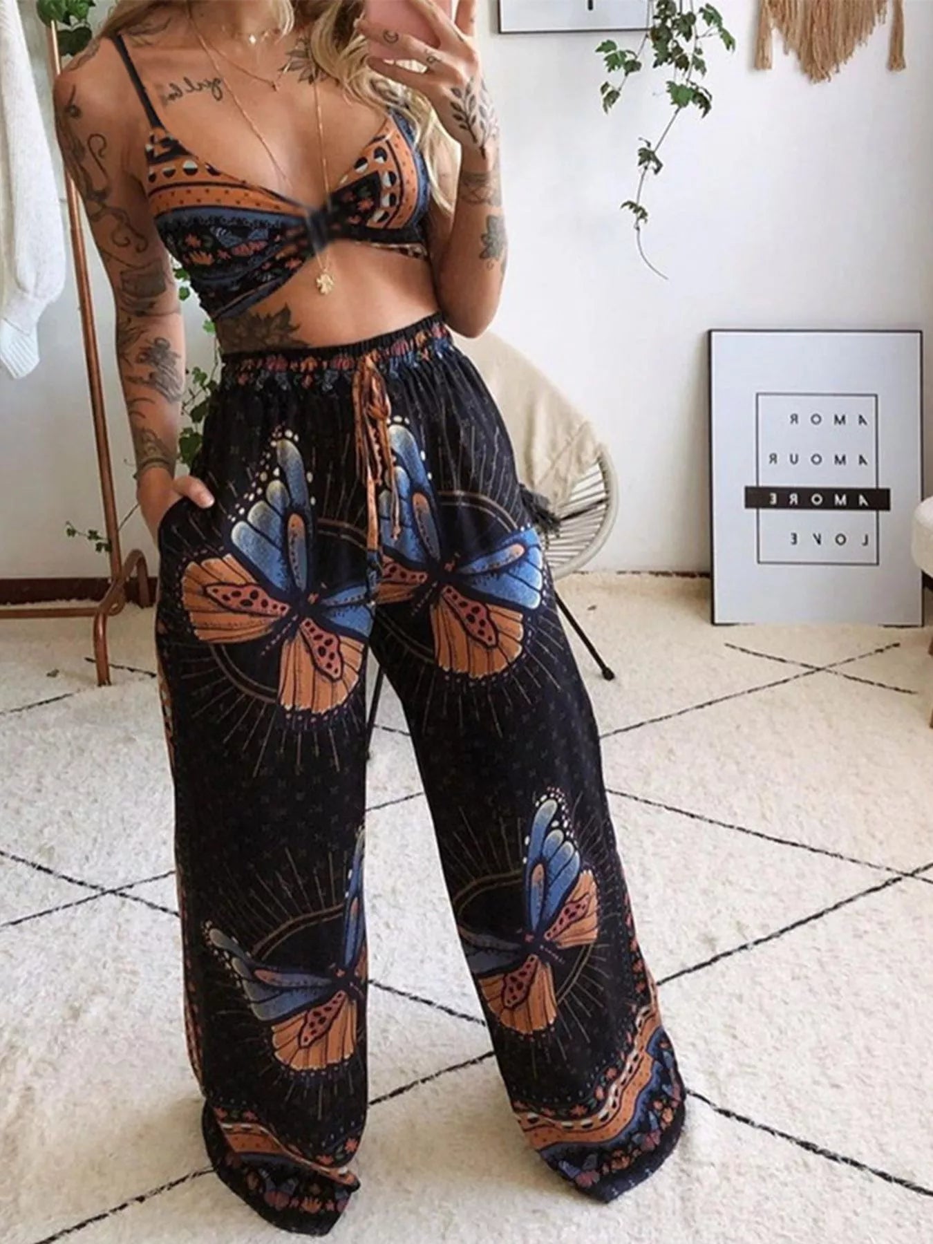 Boho butterfly-print top and pants set by Trendsi, black base with orange and blue butterfly motifs.