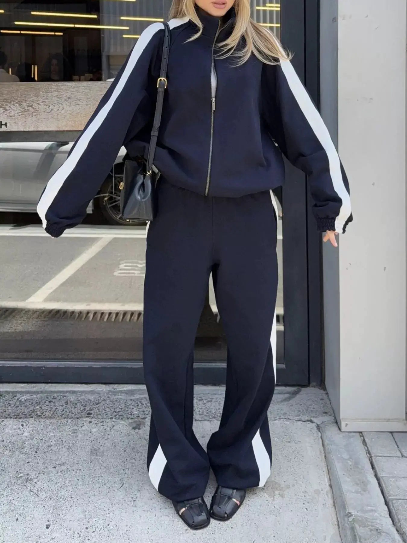 Two-piece zip-up navy Belle Bijouix activewear set with white side stripes
