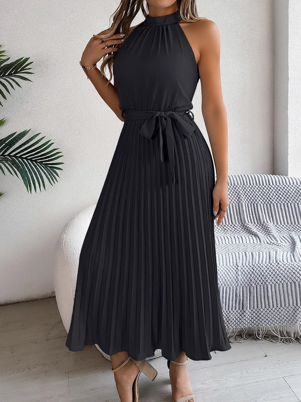 Pleated tie-waist sleeveless midi dress by Belle Bijouix, black halter-neck.