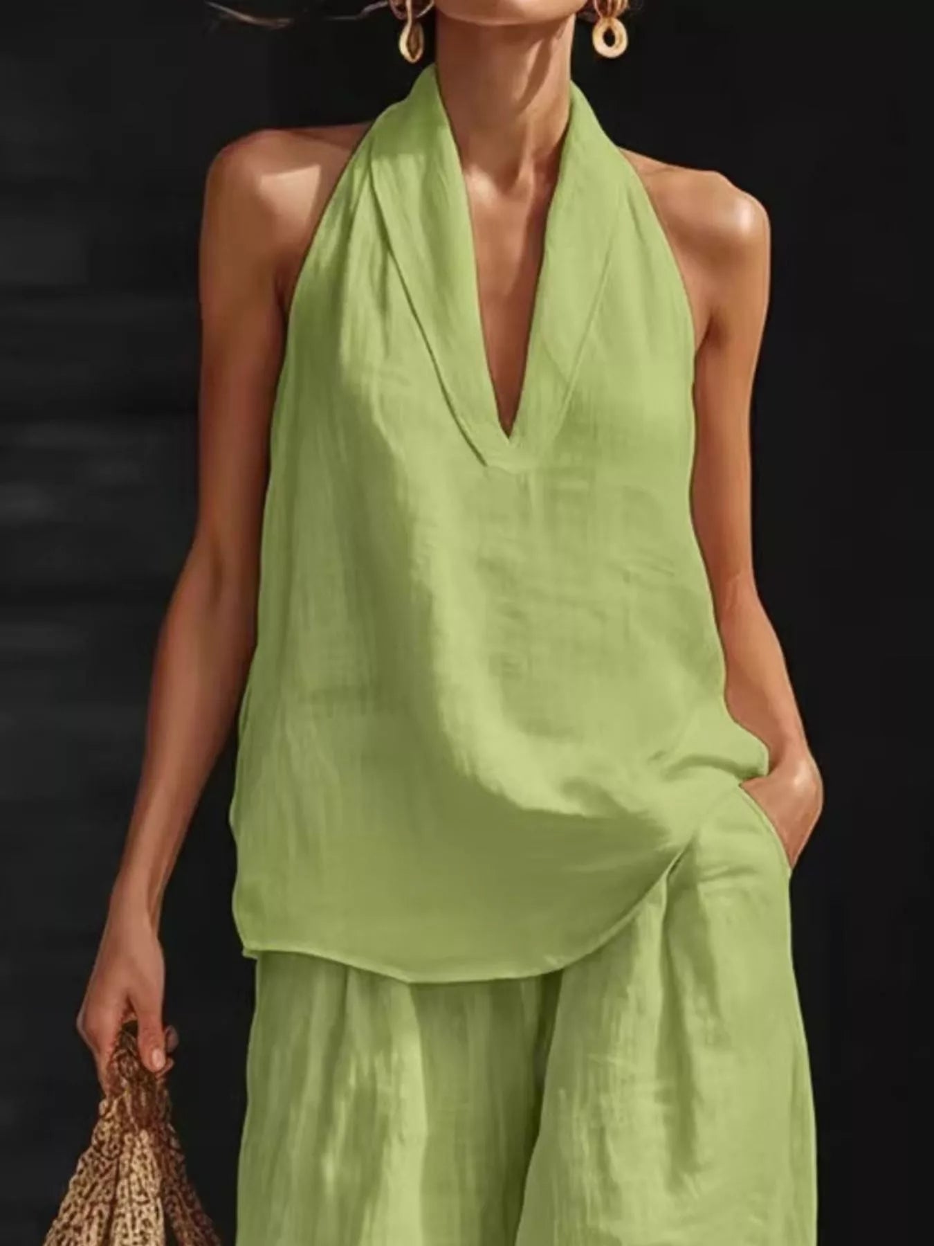 Two-piece plus-size lime green halter-neck top and wide-leg pants set by Trendsi