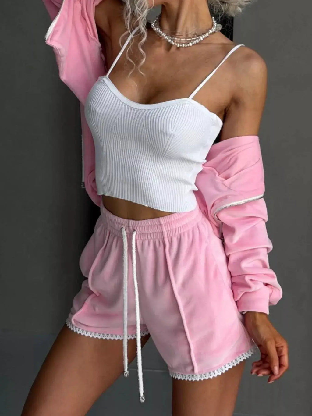 Belle Bijouix pink two-piece activewear set: zip-up hooded outerwear and lace-trim shorts with white drawstring