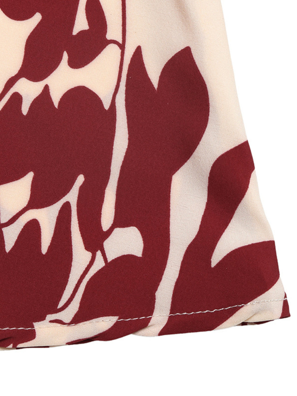 Deep V-Neck Spaghetti Strap Maxi Dress by Trendsi; beige fabric with bold red abstract print.