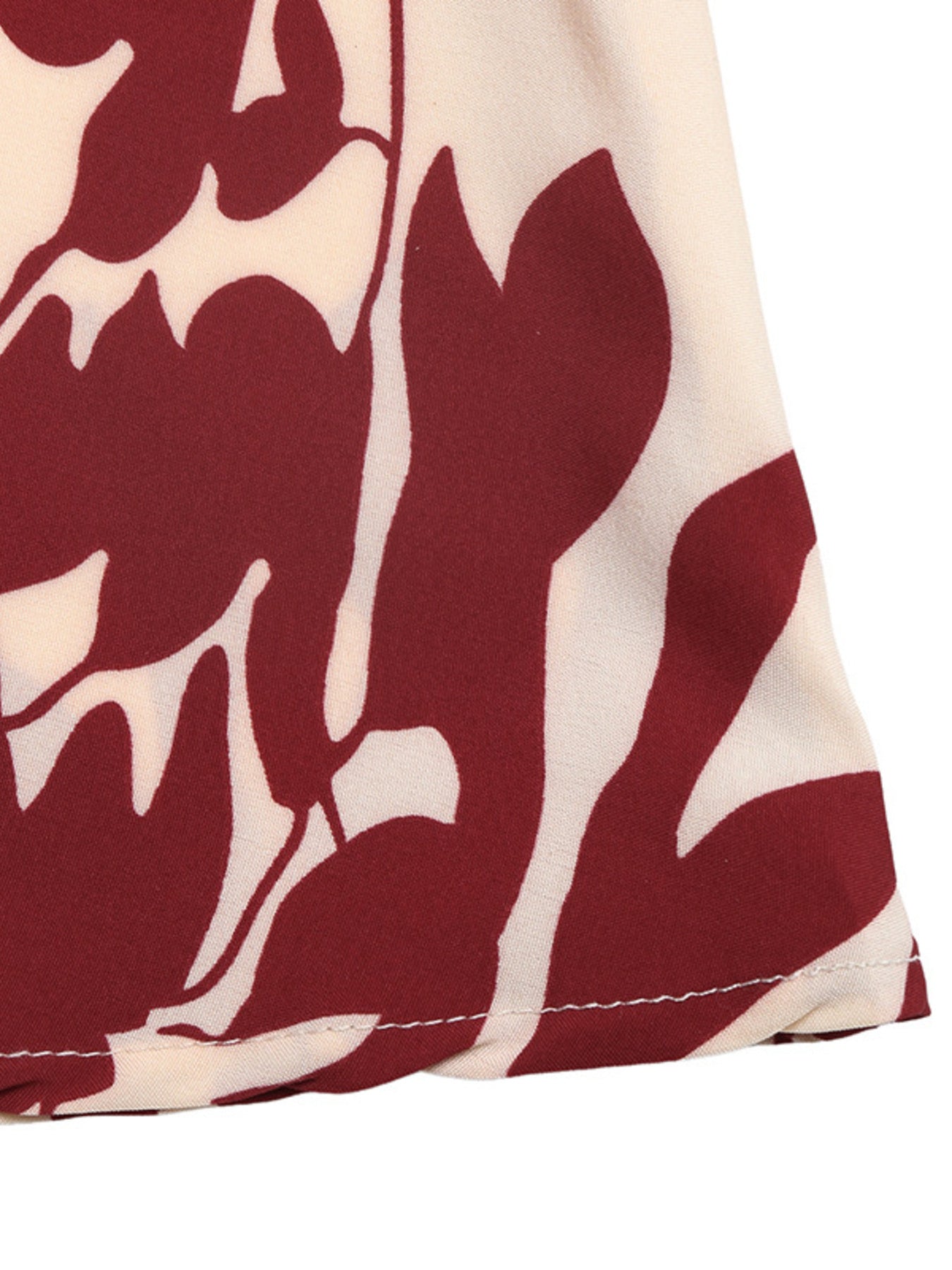 Deep V-Neck Spaghetti Strap Maxi Dress by Trendsi; beige fabric with bold red abstract print.
