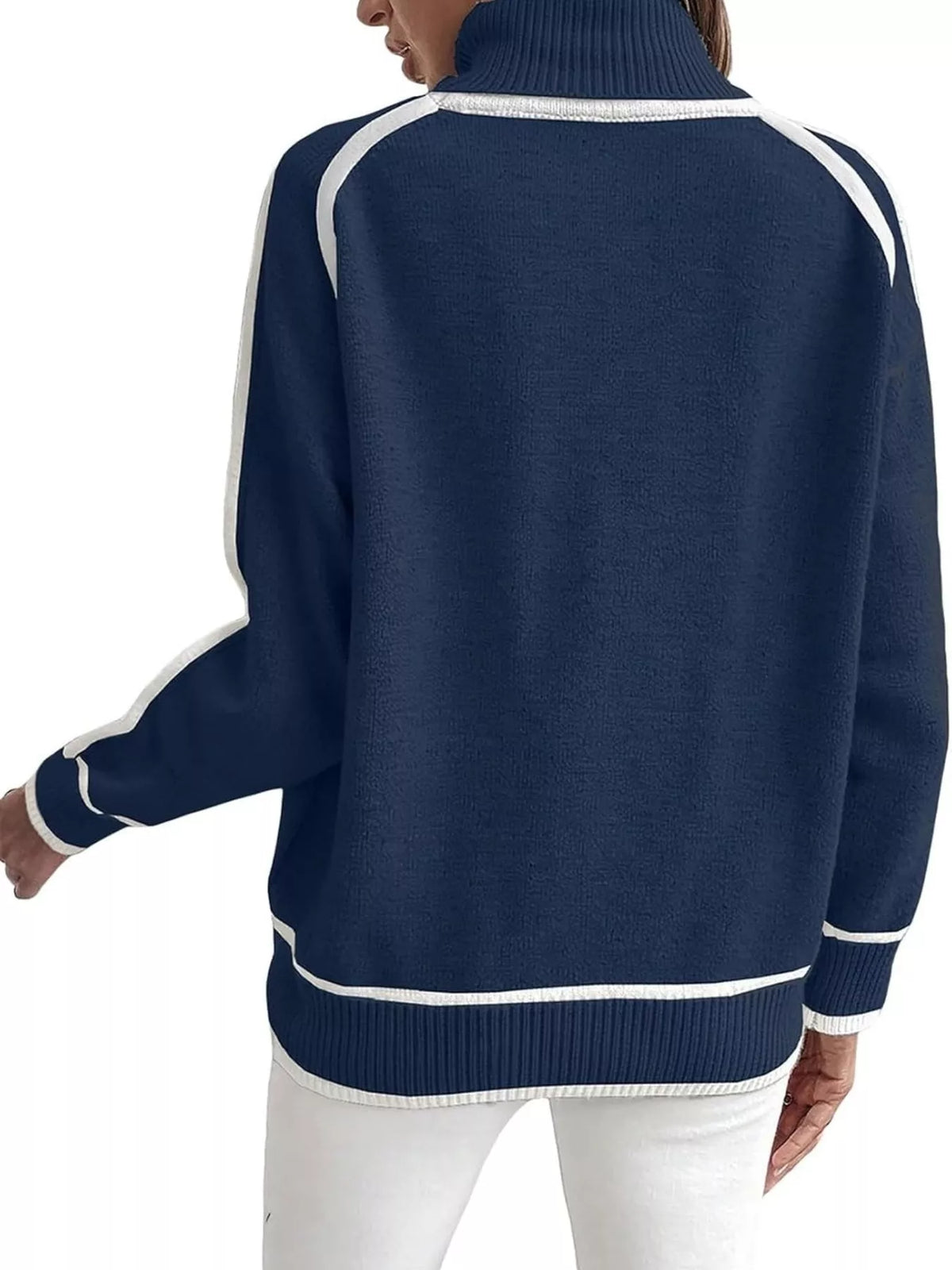 Back view of blue turtleneck sweater with white contrast trim and ribbed hem