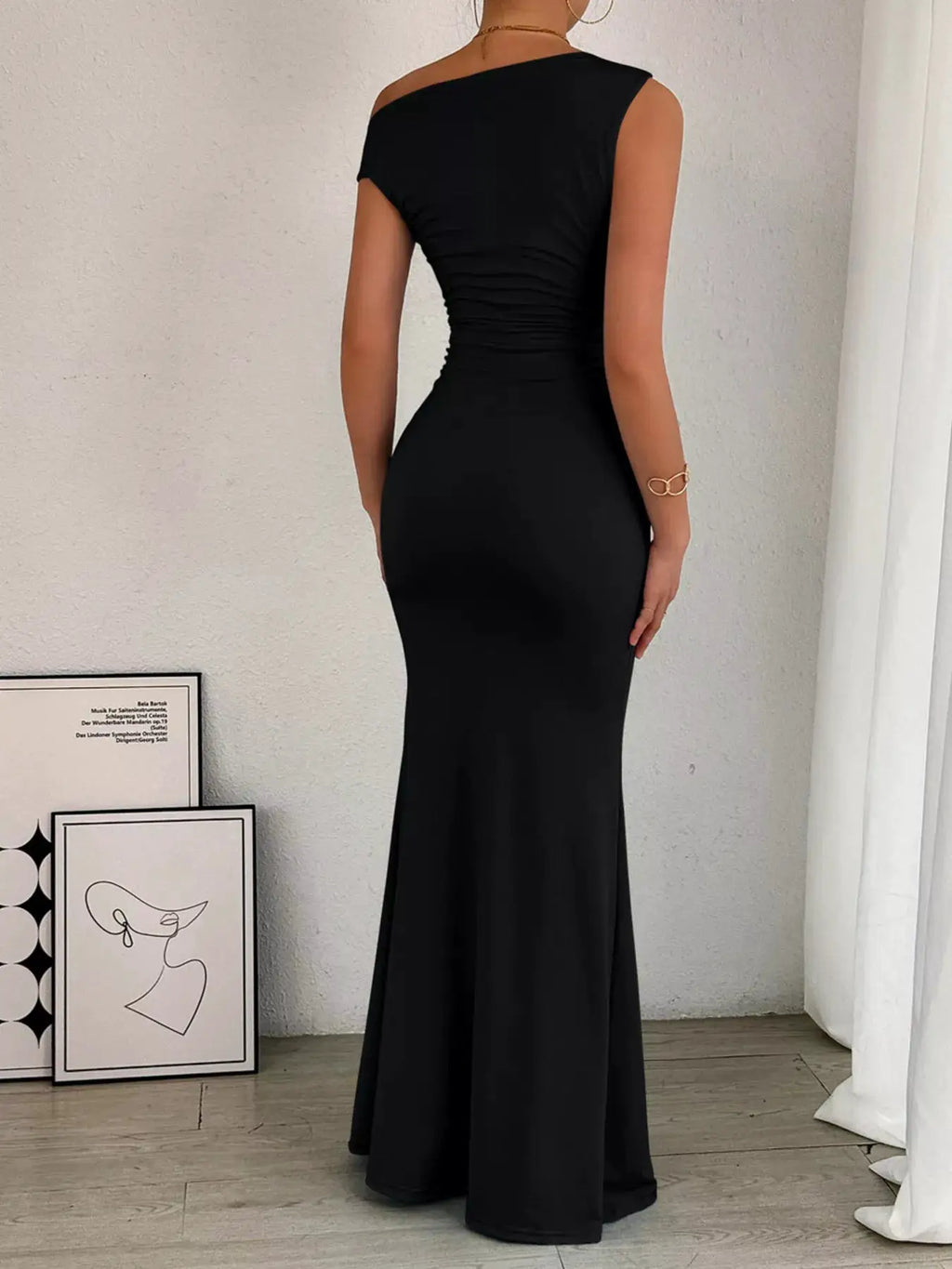 One-shoulder ruched black bodycon maxi dress with a floor-sweeping silhouette
