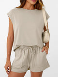 Beige two-piece set: round-neck cap-sleeve top with matching drawstring shorts.