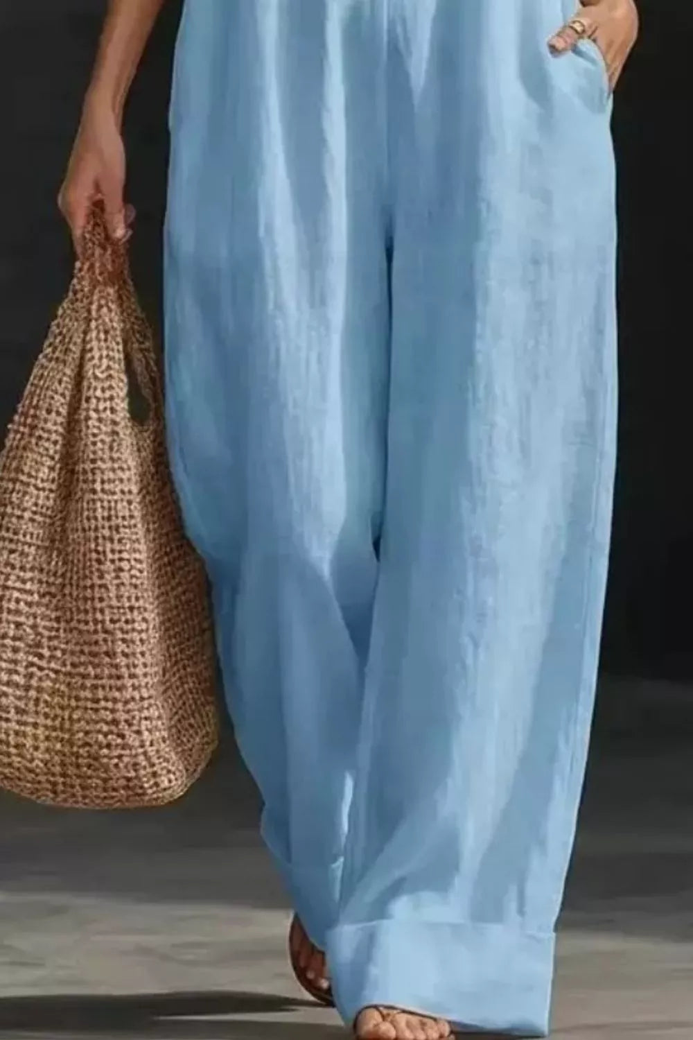 Sleeveless Wide Leg Jumpsuit by Trendsi in light blue with a brown woven tote bag