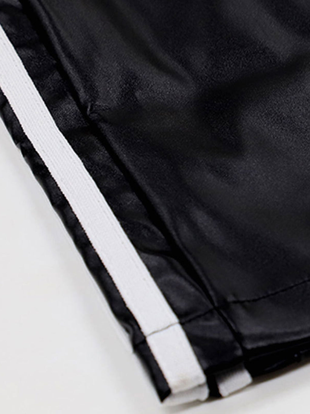 Striped wide-leg pants in black fabric with white stripe trim.