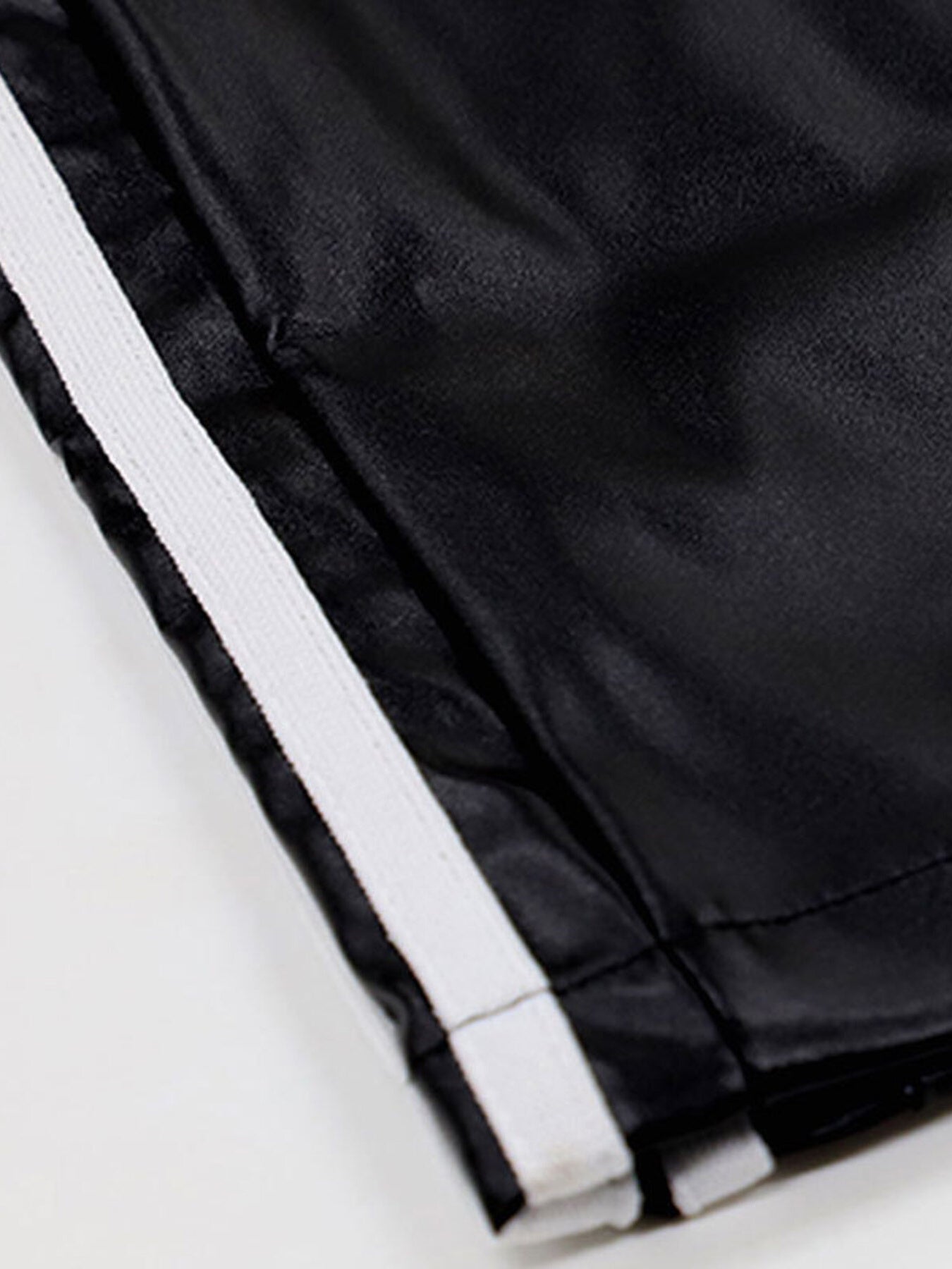 Striped wide-leg pants in black fabric with white stripe trim.
