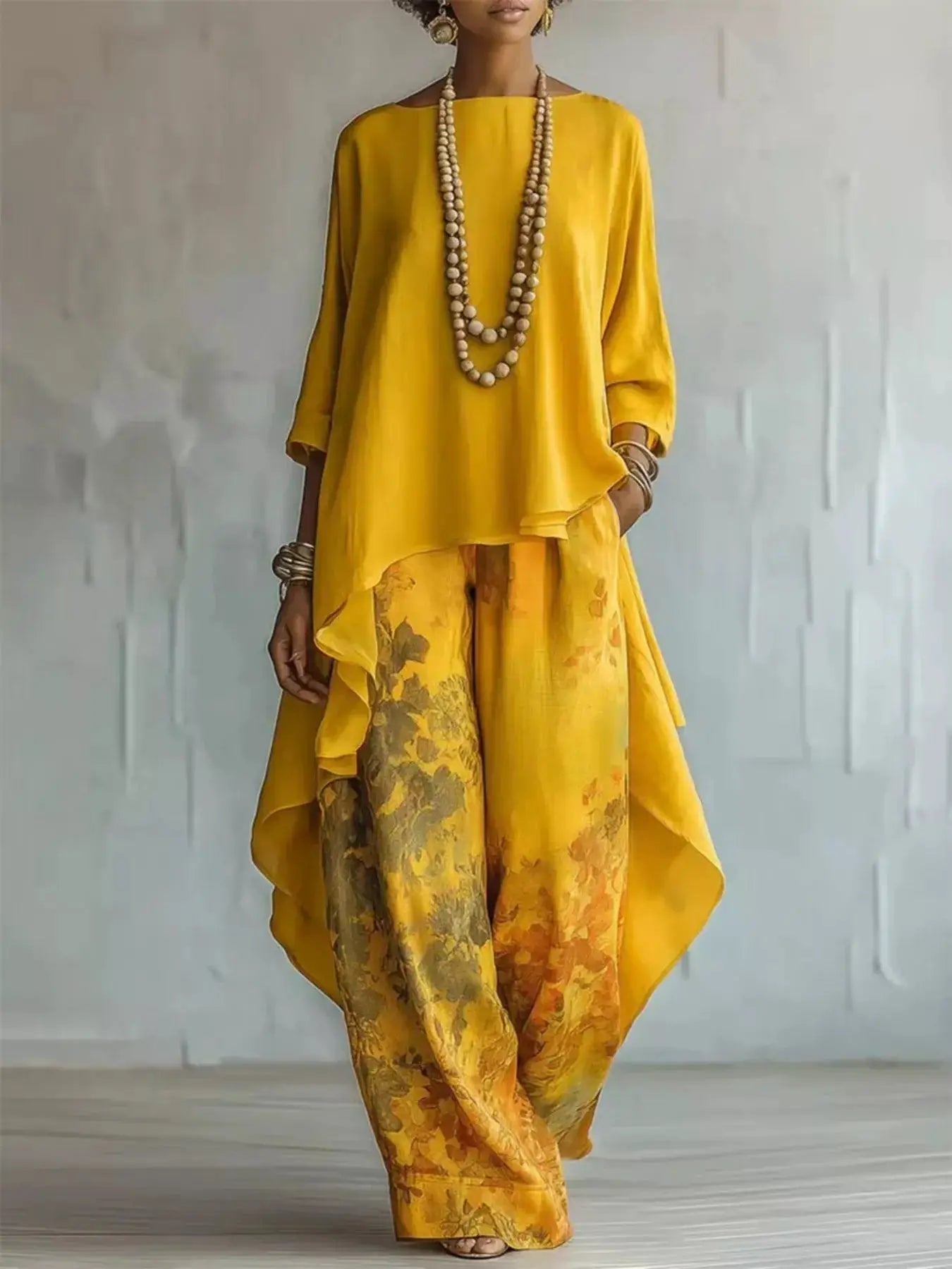 Asymmetrical Hem Top and Floral Pants Set in bright yellow with floral-print pants; model wears layered beaded necklaces.