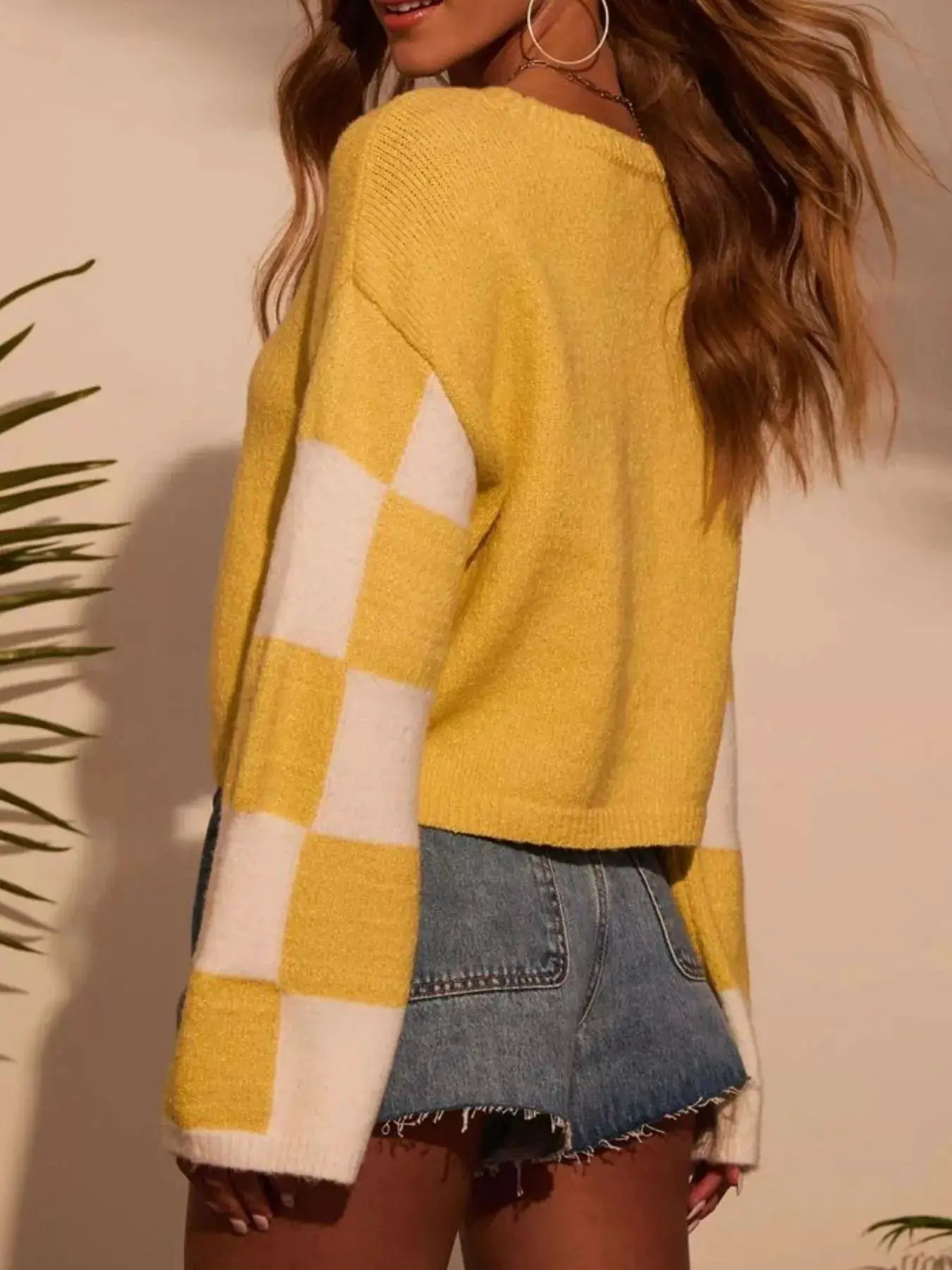 Color Block Long Sleeve Sweater; bright yellow with white sleeve blocks, knit texture, styled with denim shorts