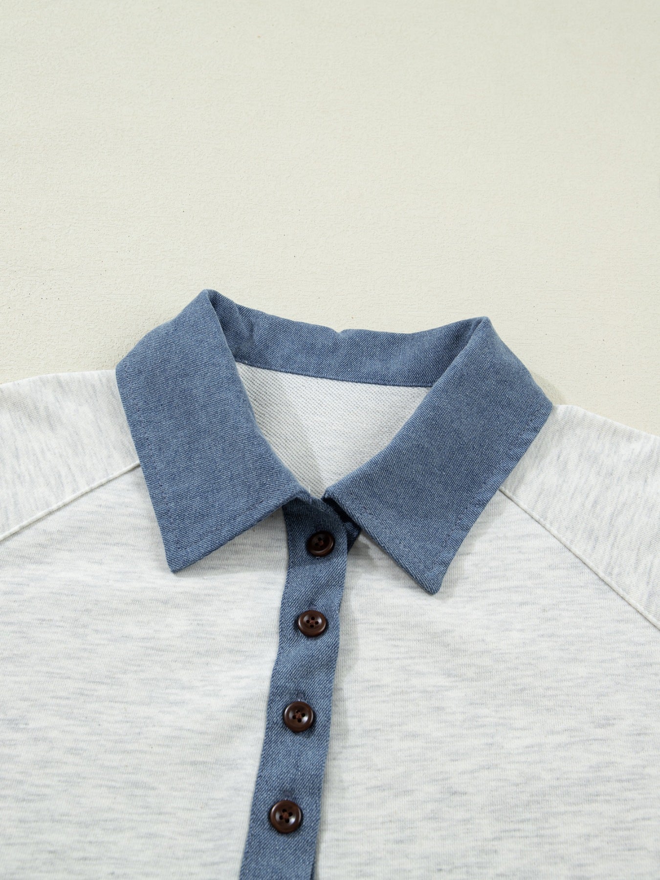 Contrast-trim button-detail top with grey body and blue denim collar by Trendsi.