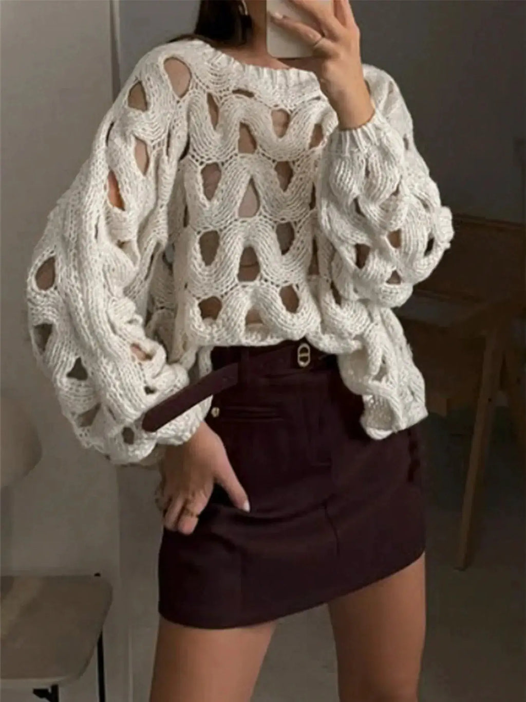 Chunky cable-knit hollow-out sweater in white with oversized sleeves.