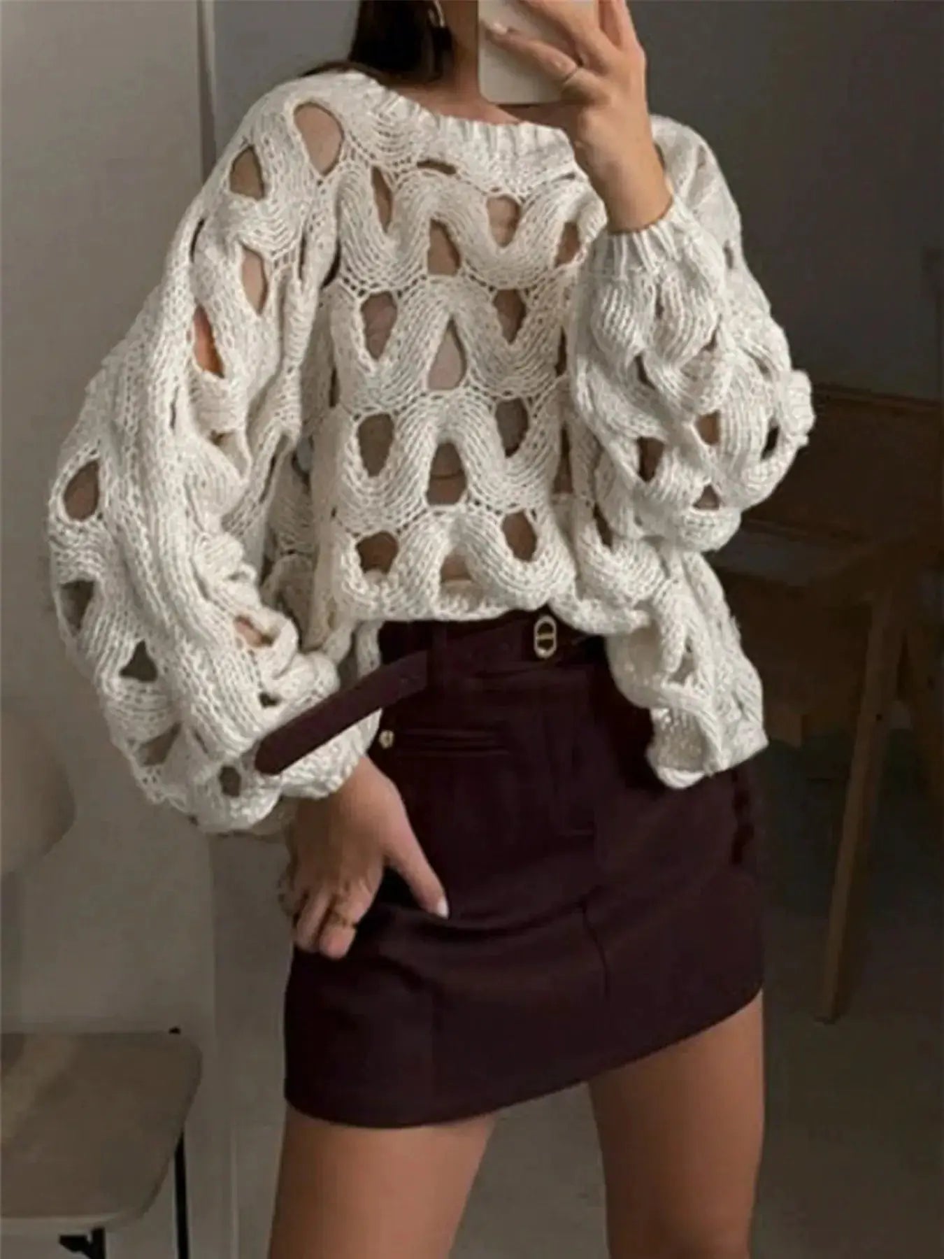 Chunky cable-knit hollow-out sweater in white with oversized sleeves.
