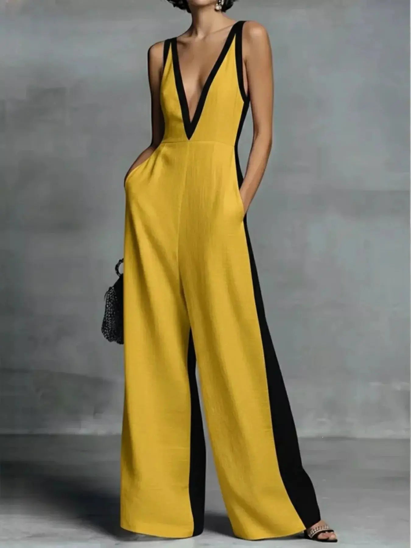One-piece jumpsuit in yellow with deep V-neck and black contrast trim, wide-leg design