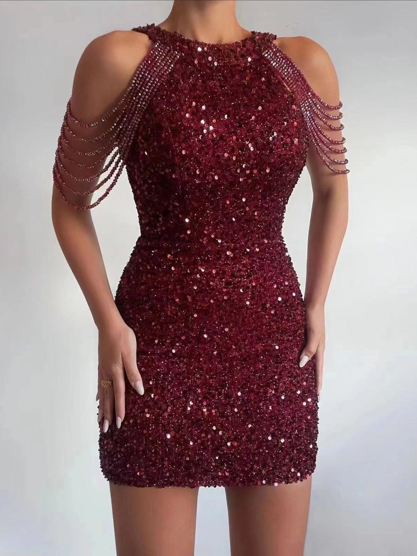 Full-Size Sequin Embellished Bodycon Mini Dress Plus Size by Trendsi, burgundy with chain-draped cold-shoulder sleeves.