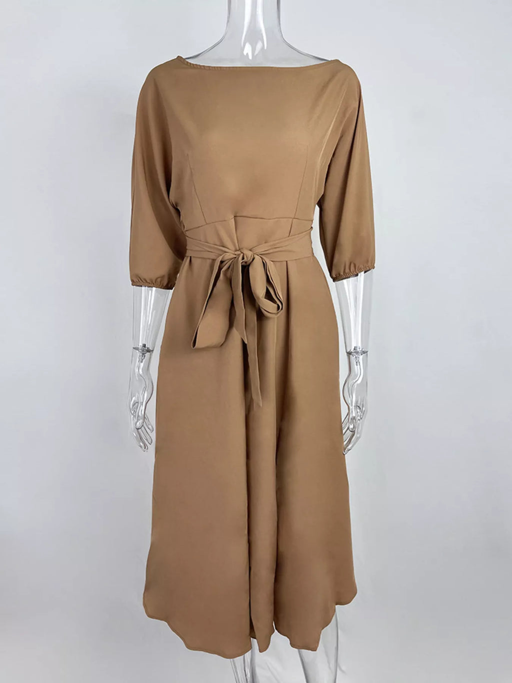 Boat neck tie-waist dress by Trendsi in camel/tan with a waist bow and 3/4 sleeves.
