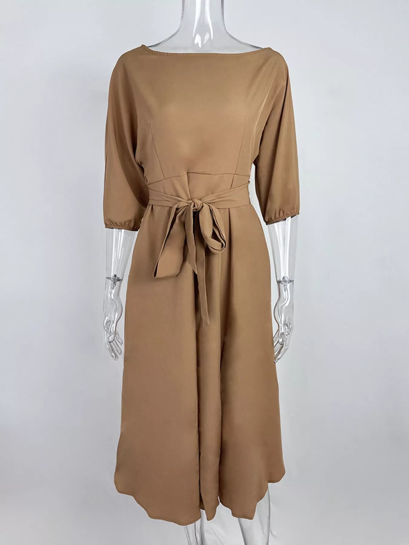 Boat neck tie-waist dress by Trendsi in camel/tan with a waist bow and 3/4 sleeves.