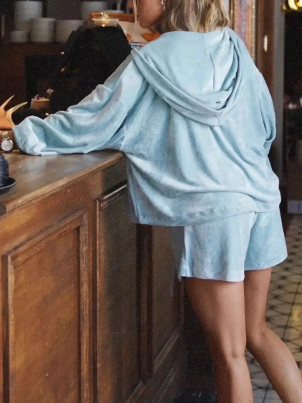 Zip-up hoodie and shorts two-piece activewear set in light blue.
