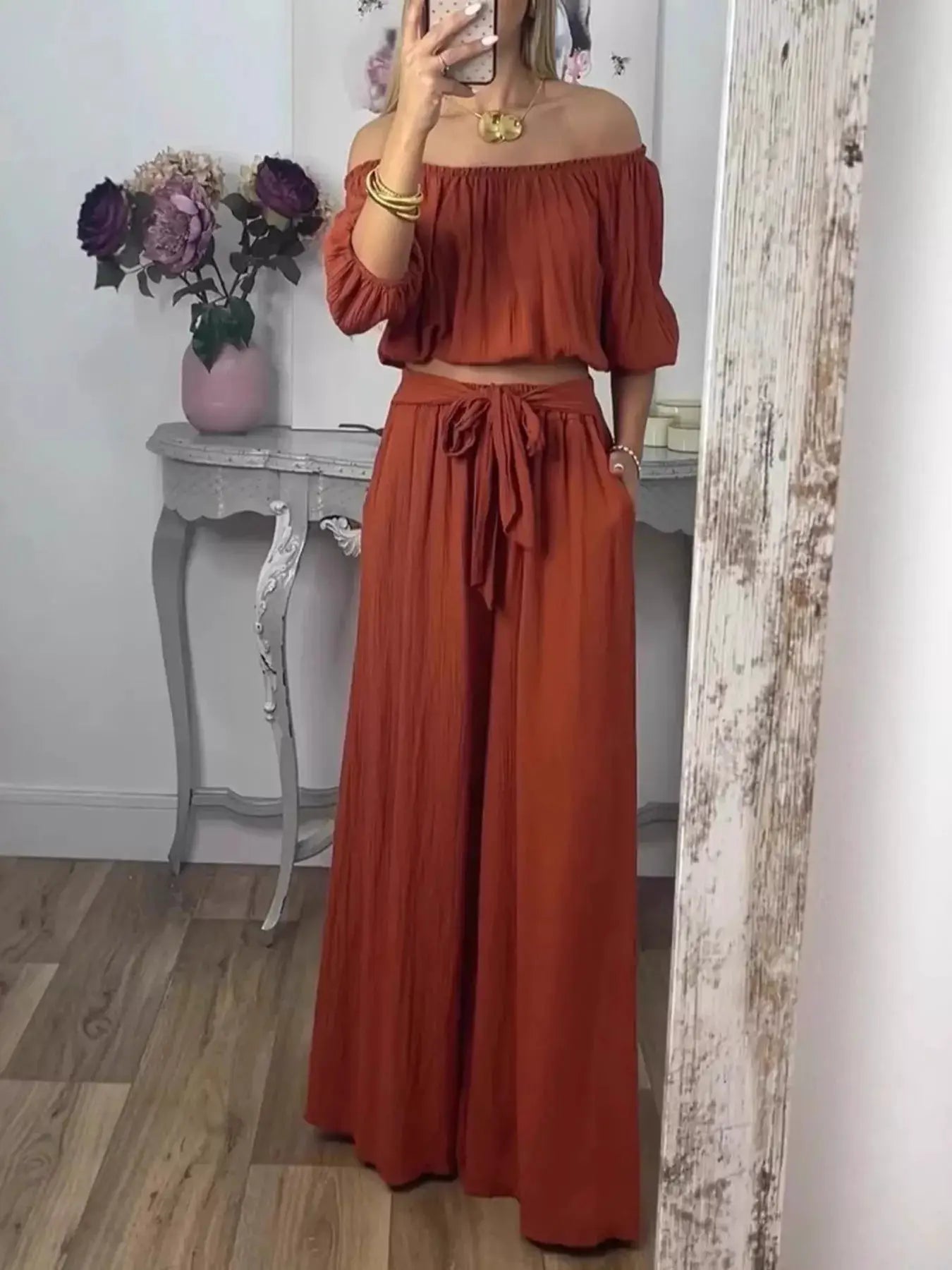 Full Size Off-Shoulder Top and Pants Set by Belle Bijouix; rust-orange loungewear with smocked top and tied waist pants