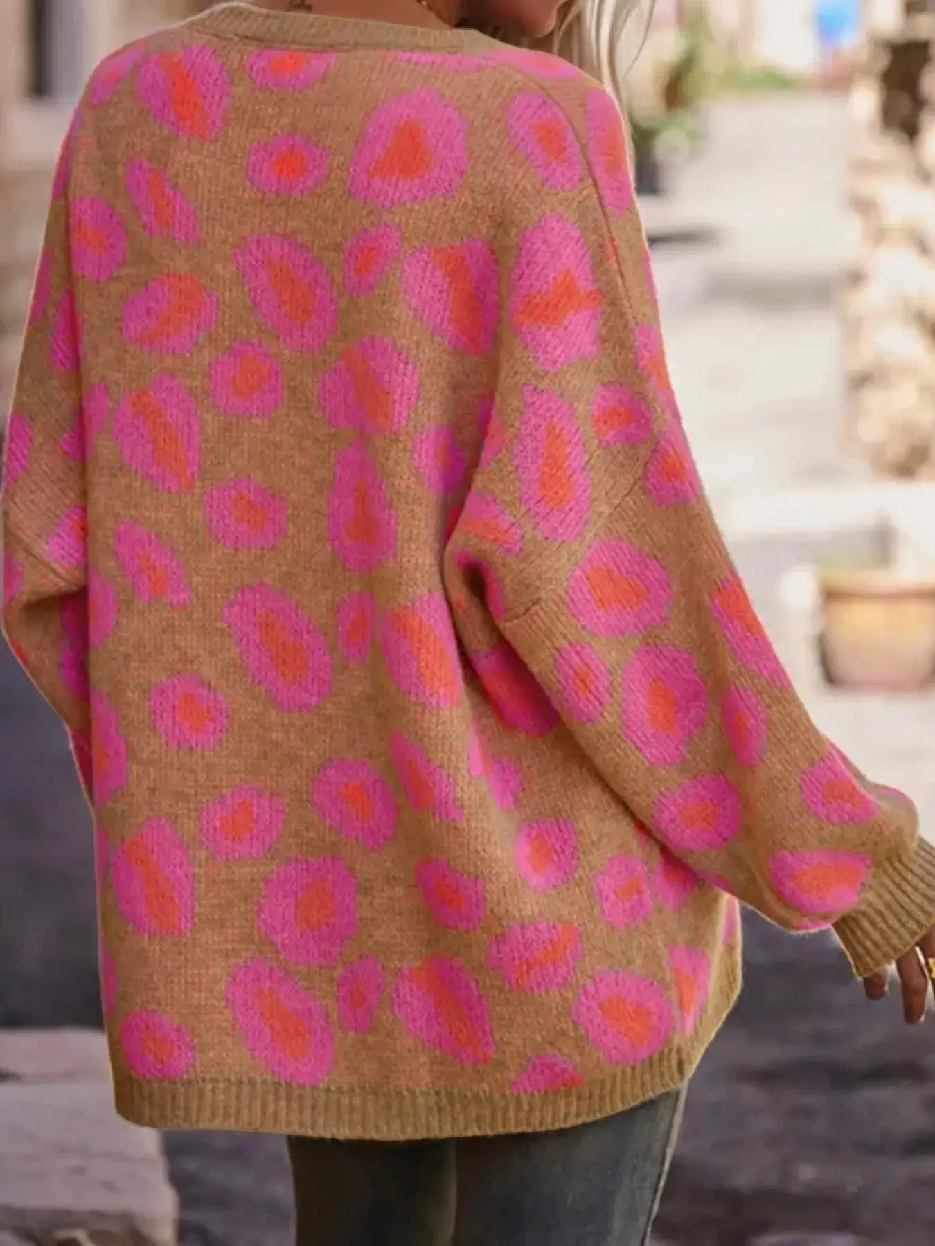 Leopard-print oversized V-neck sweater by Belle Bijouix in tan with pink spots