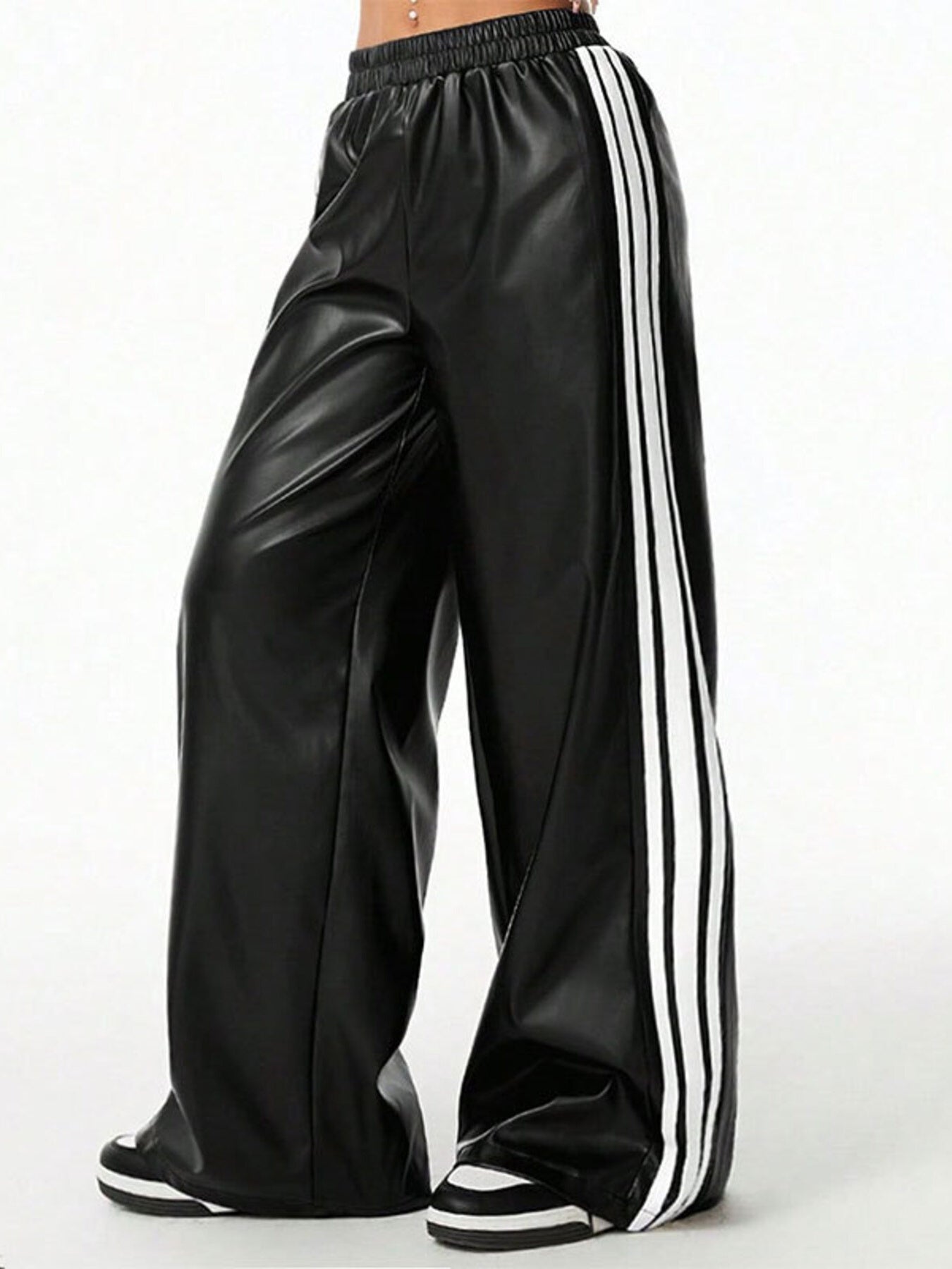 Striped wide-leg pants in black faux leather with white side stripes, by Trendsi