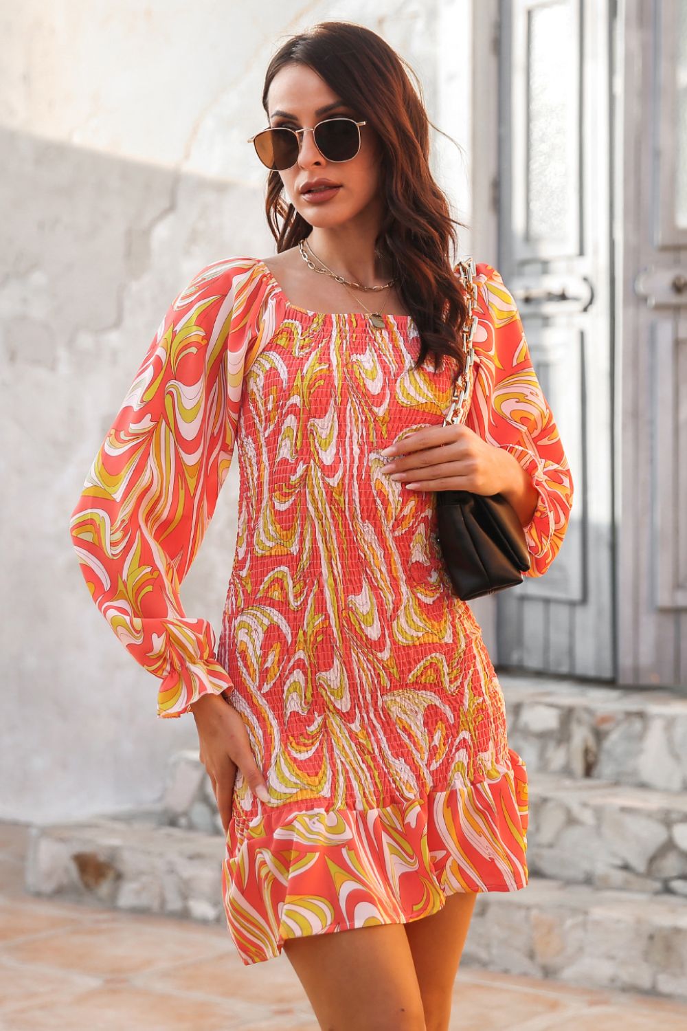 Abstract Print Square Neck Smocked Dress in coral pink with yellow swirls; long puff sleeves