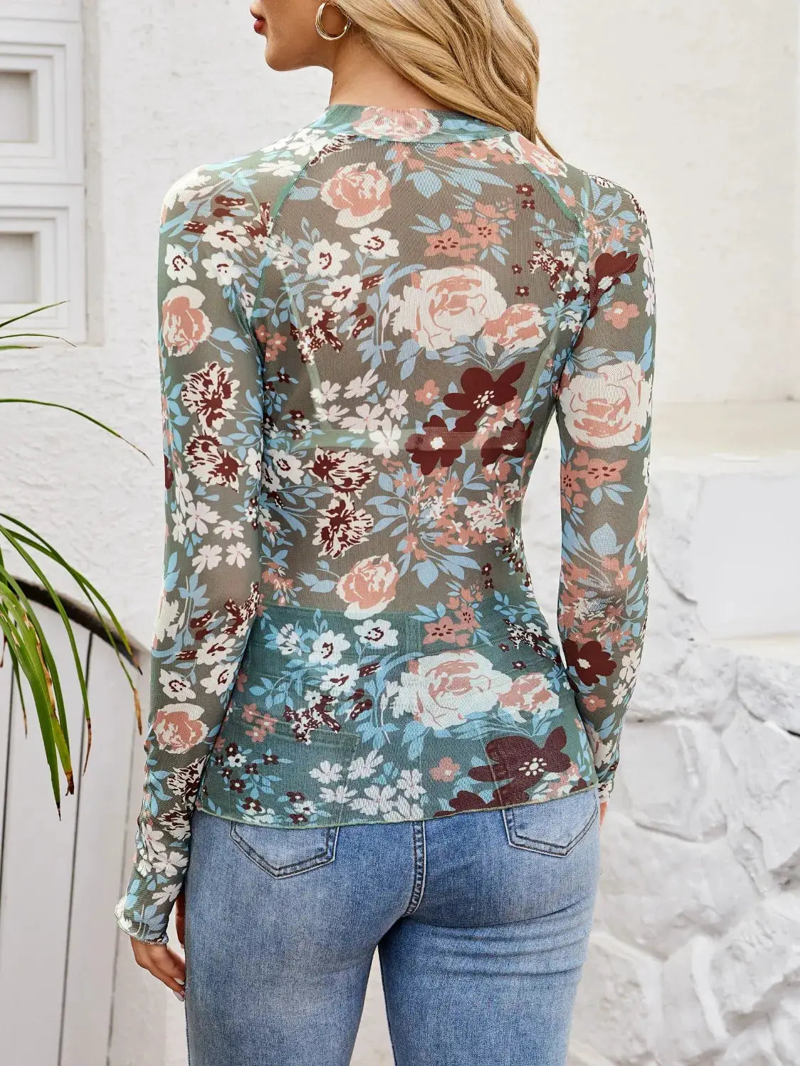Floral mock-neck long-sleeve top in sheer teal fabric with pink, white and burgundy blossoms
