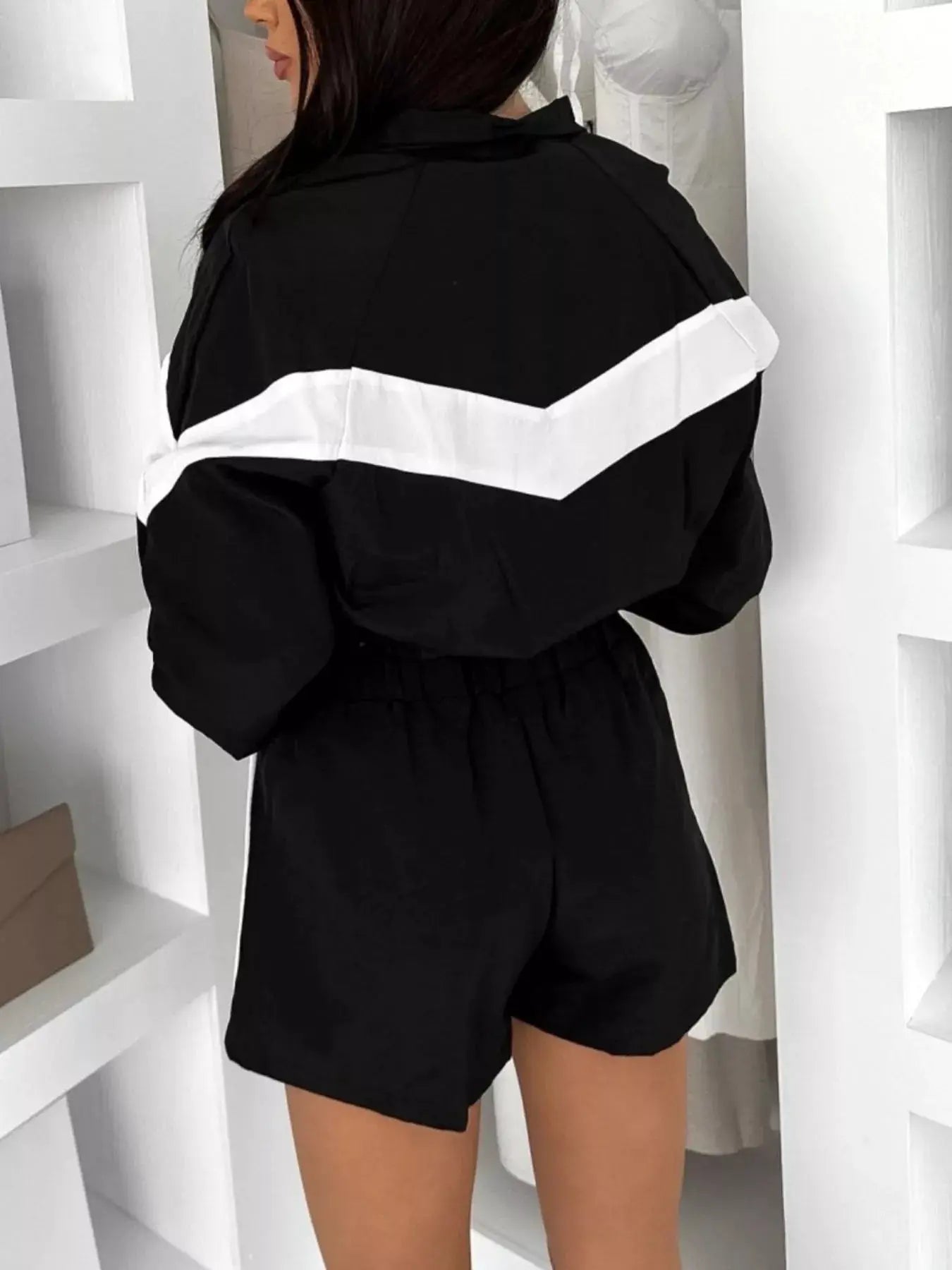 Zip-Up Long Sleeve Outerwear & Shorts Set in black with a white chevron stripe, back view.