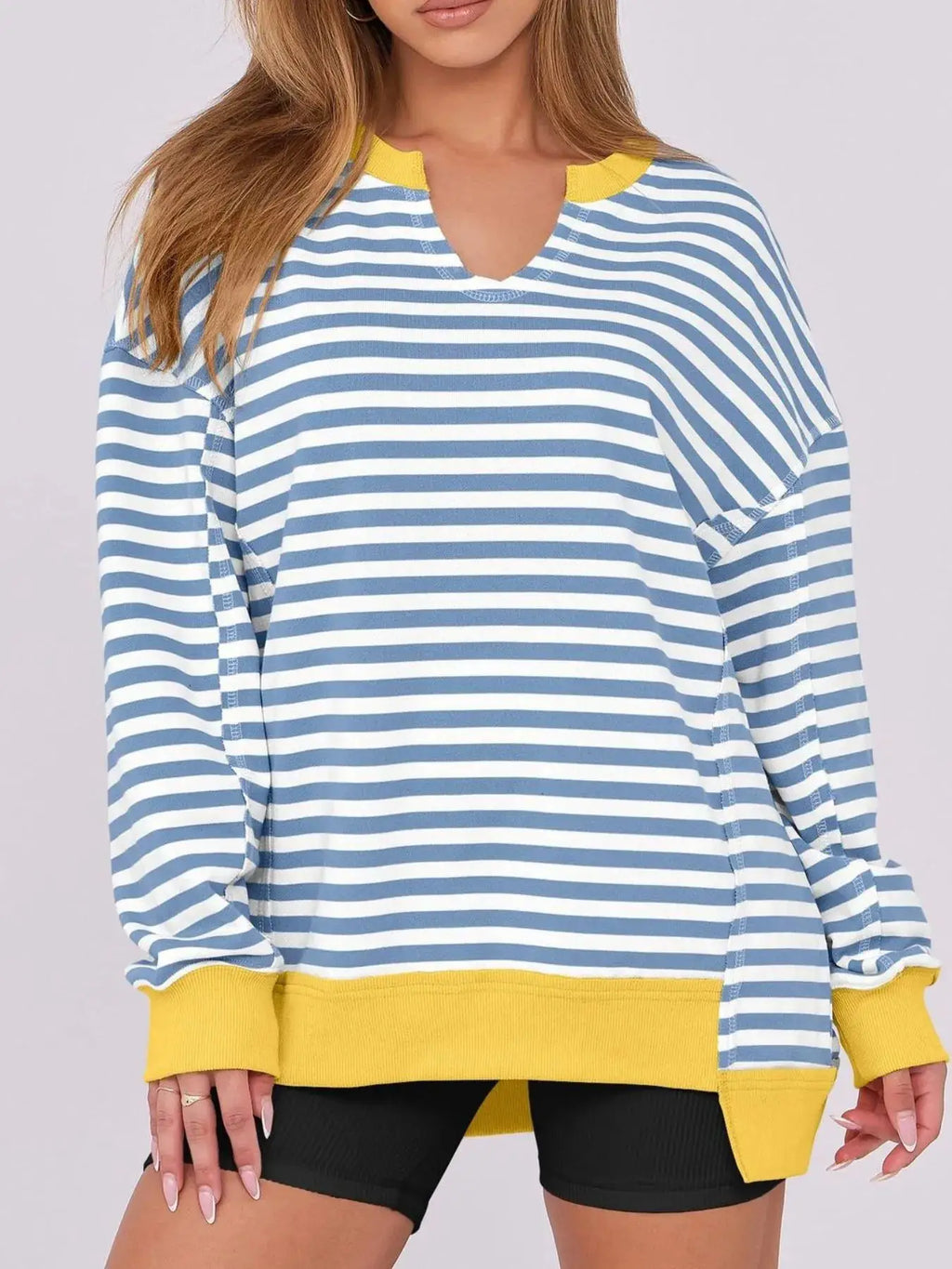 Notched long sleeve oversized sweatshirt, blue and white striped with yellow ribbed cuffs and hem.