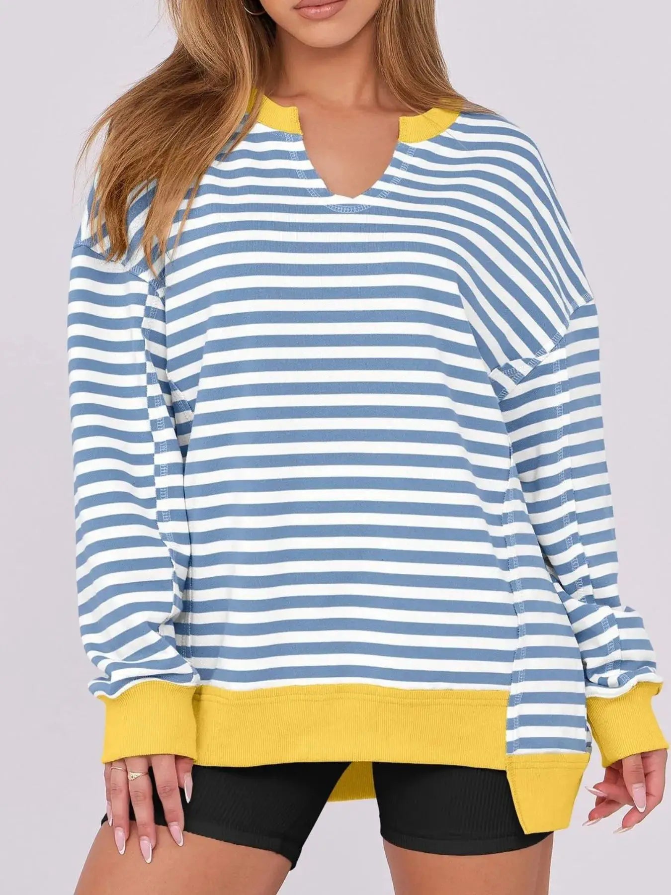 Notched long sleeve oversized sweatshirt, blue and white striped with yellow ribbed cuffs and hem.