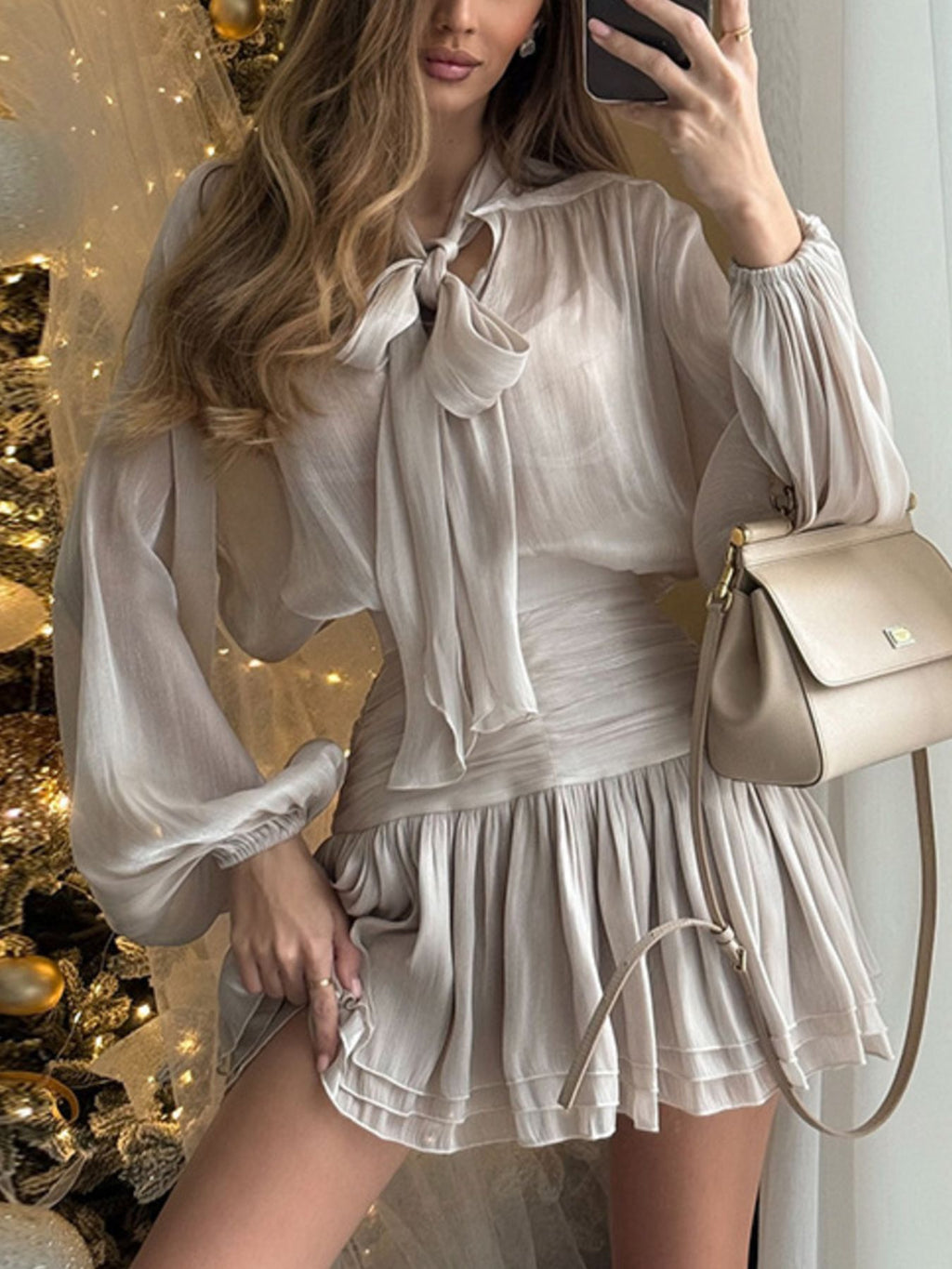 Bow-Tie Blouse and Ruched Mini Skirt Set by Trendsi in cream-beige; sheer blouse with bow neck.