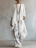 Outfit set: Asymmetrical Hem Top and Floral Pants by Belle Bijouix, ivory top with gray floral pants.